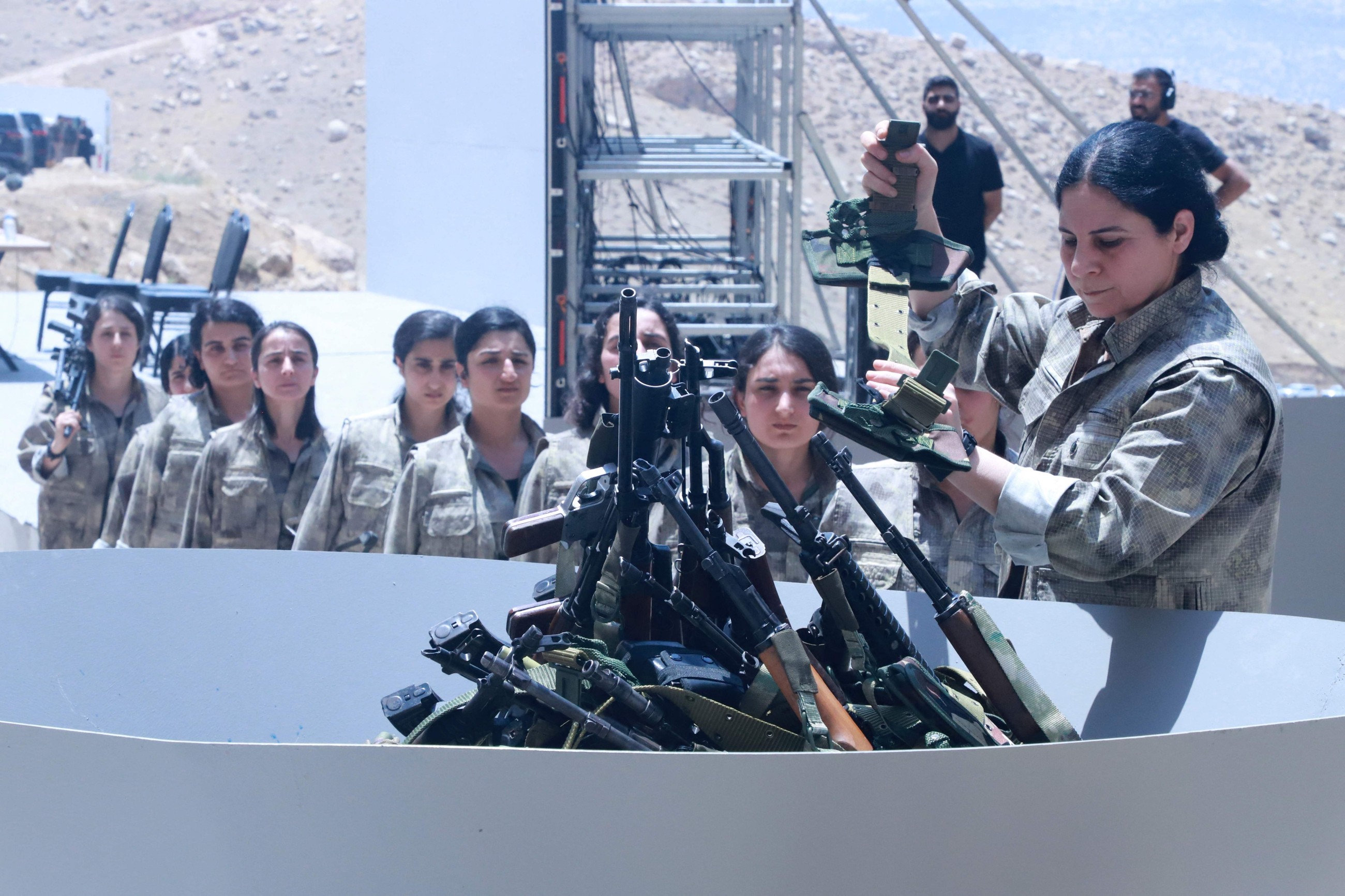 Kurdish PKK fighters destroy their weapons at disarmament ceremony