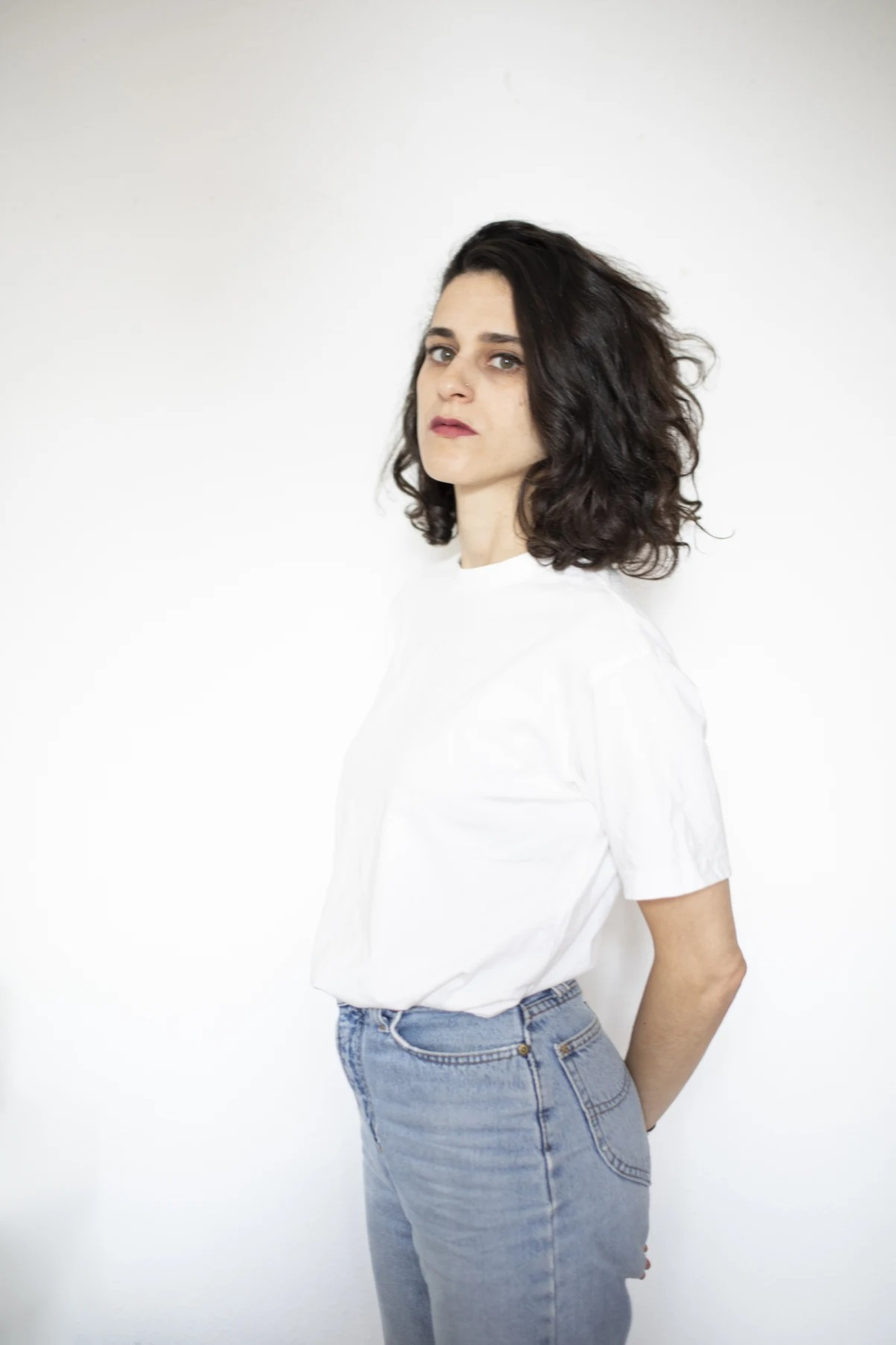 Palestinian artist Ruba Salameh works on the canvas of art in the face of killings