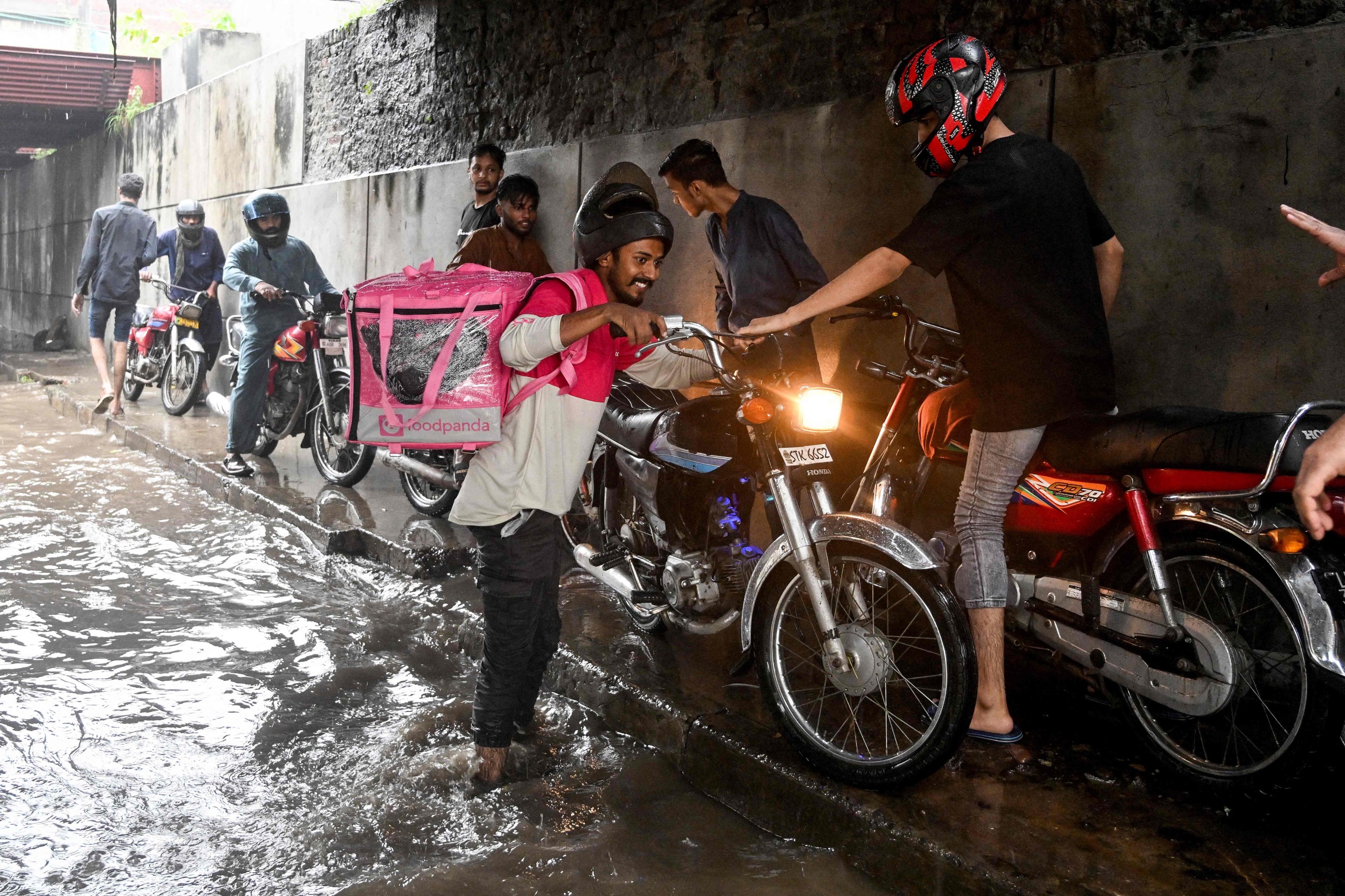 No pause for food delivery riders during Pakistan's monsoon