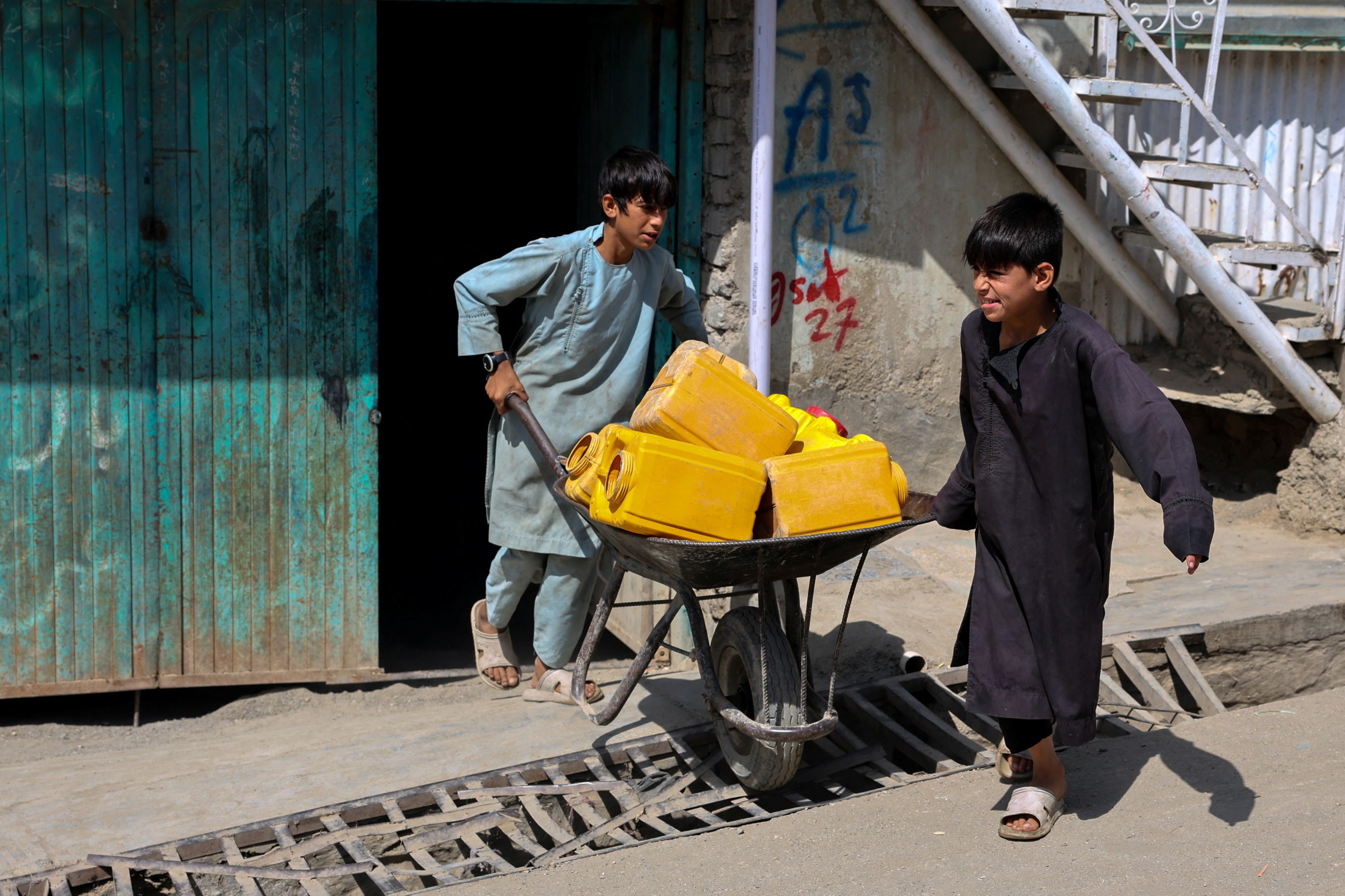 Water is life: Afghan capital's wells run dry, driving children out of class and into water queues
