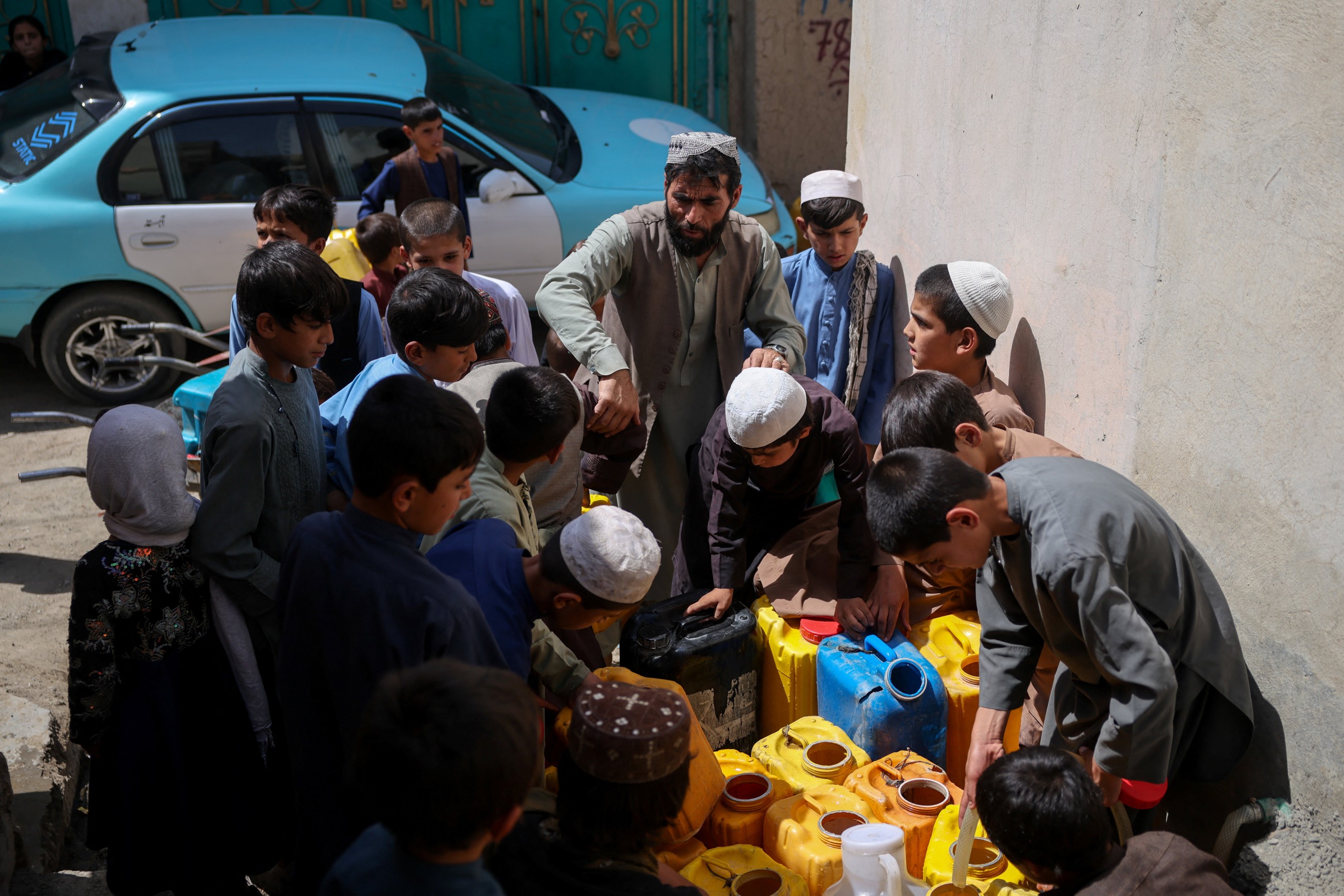 Water is life: Afghan capital's wells run dry, driving children out of class and into water queues