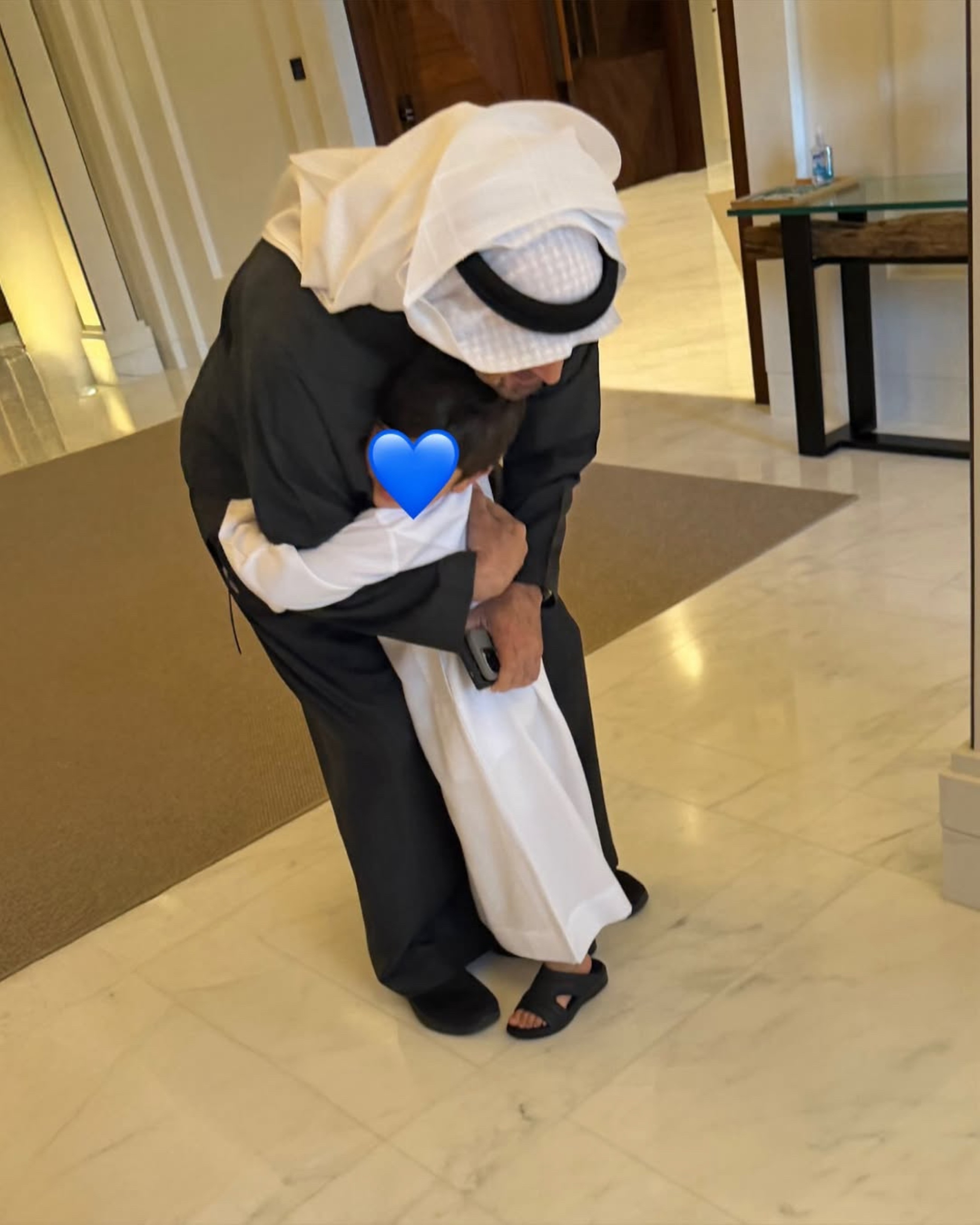 Sheikh Mohamed Bin Zayed embracing Sheikh Hamdan’s son.