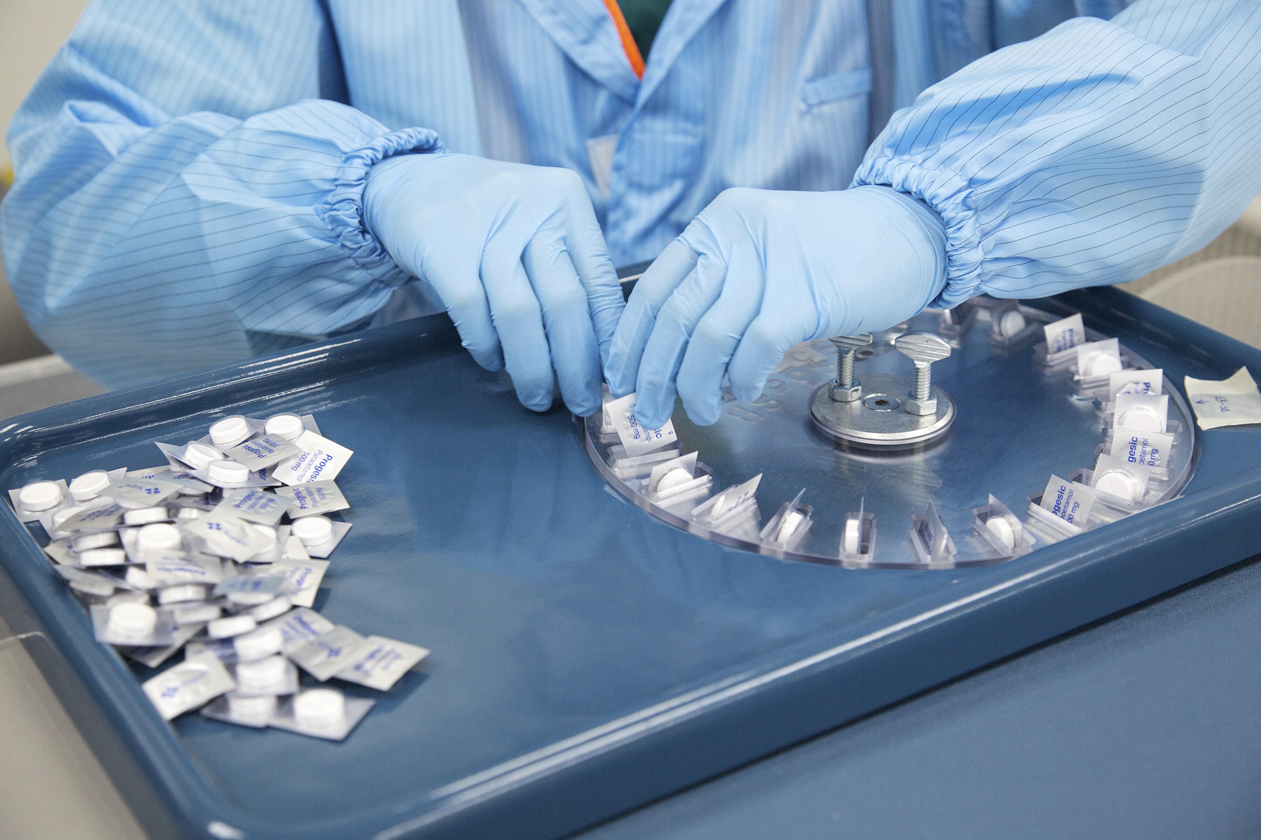 An employee repacks Progesic paracetamol tablets. 