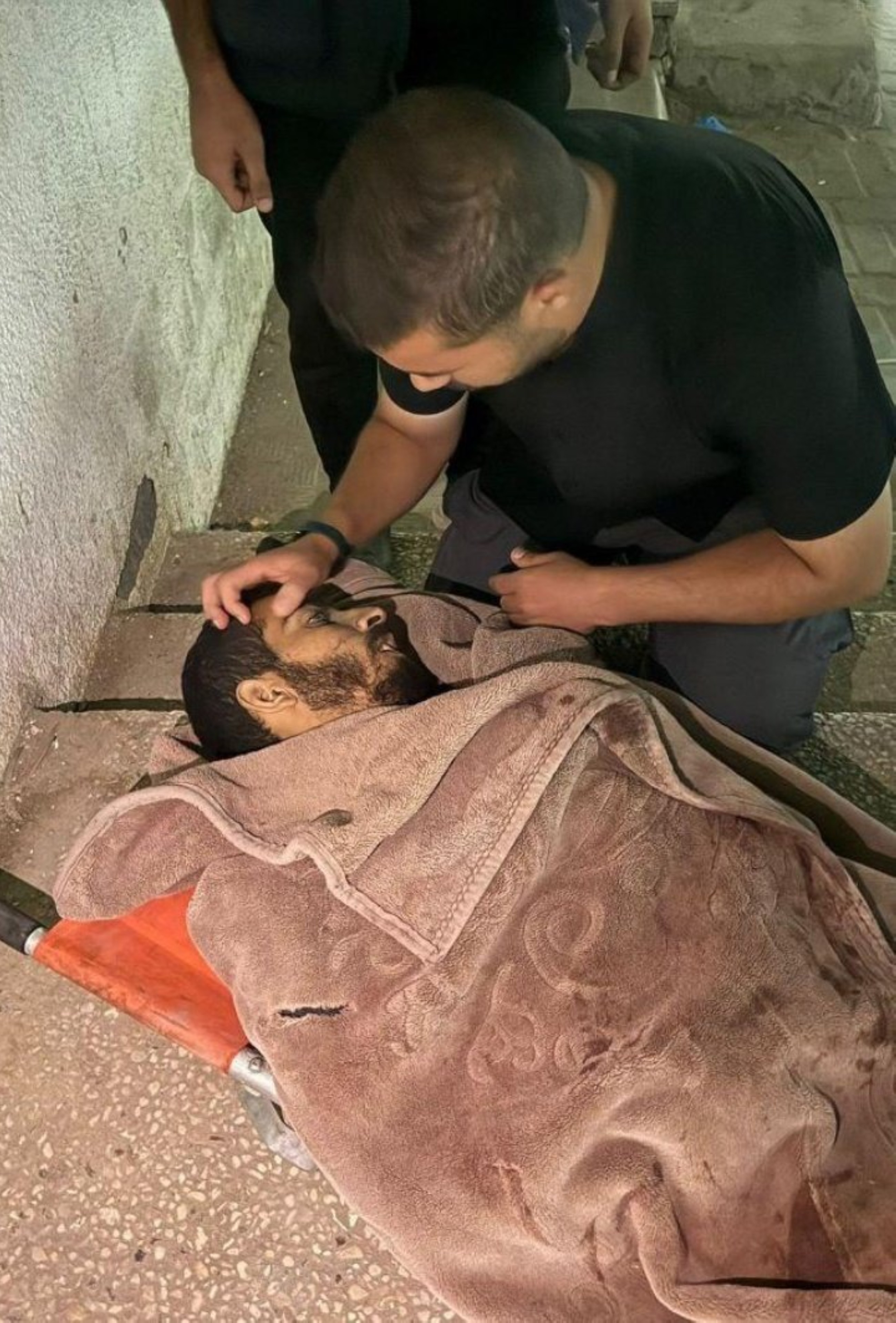 A Gazan mourns over the body of Saleh Aljafarawi at a hospital in Gaza. 