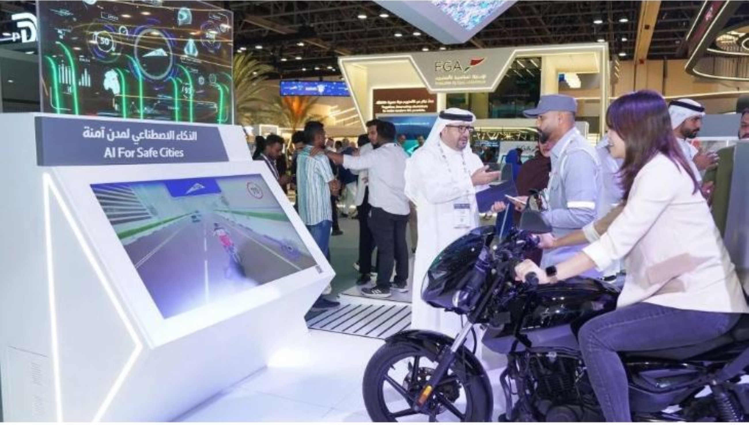 A woman demonstrates AI feature on a motorbike at GITEX Global 2025 in Dubai. 