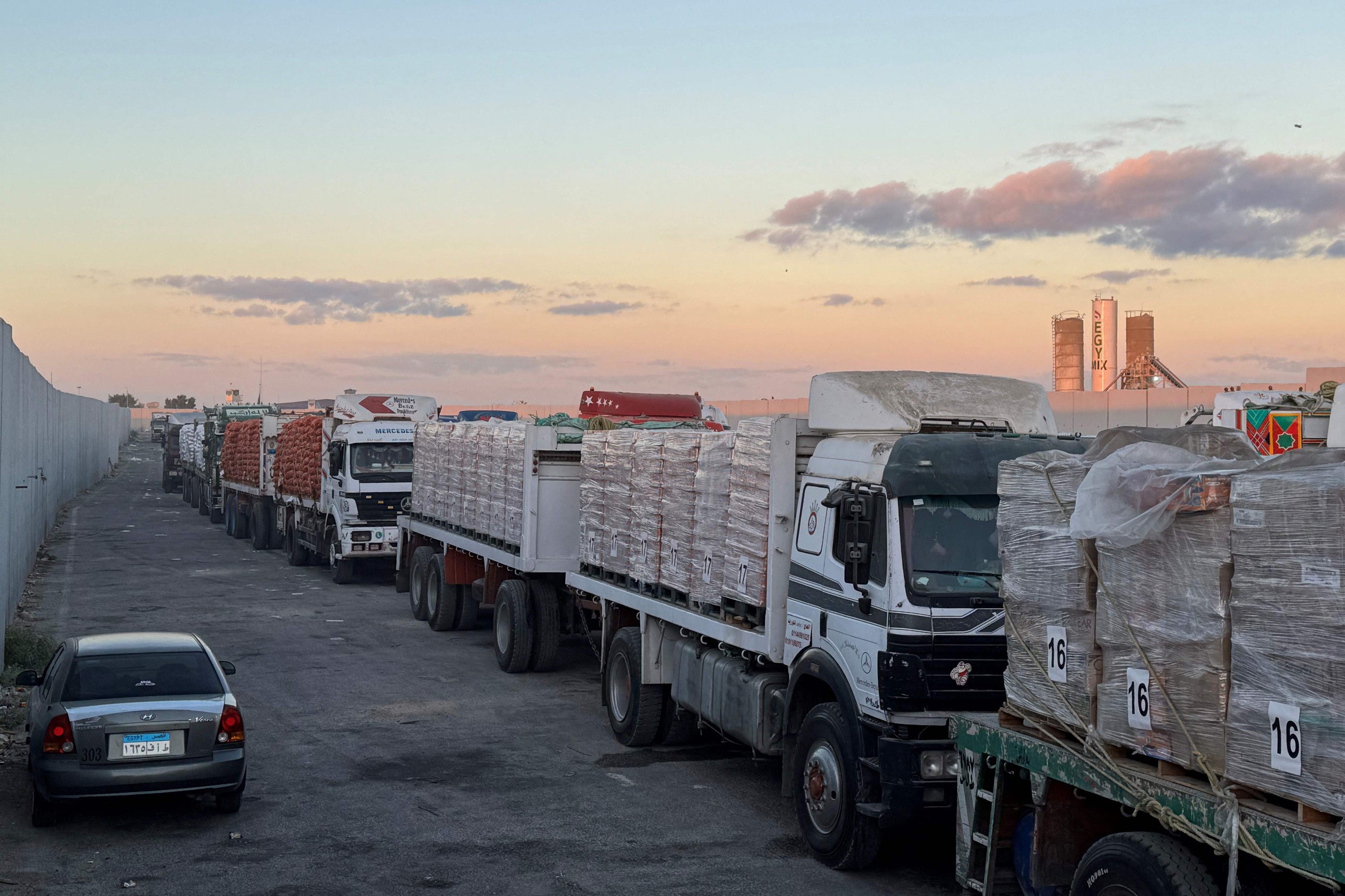 Aid trucks roll into Gaza as dispute over hostage bodies is paused