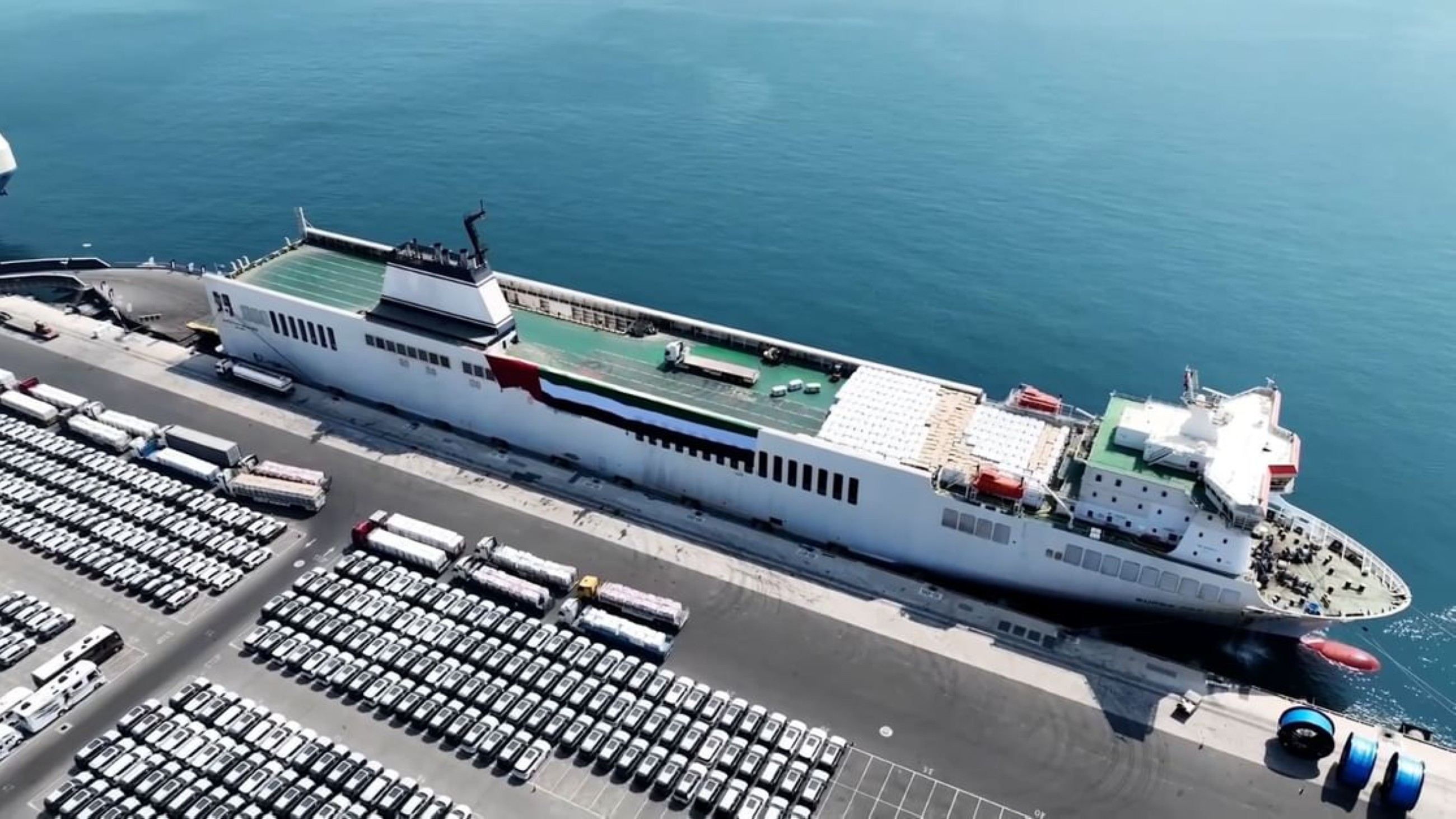 An aerial view shows pallets of aid are loaded onto a UAE Humanitarian Ship. 