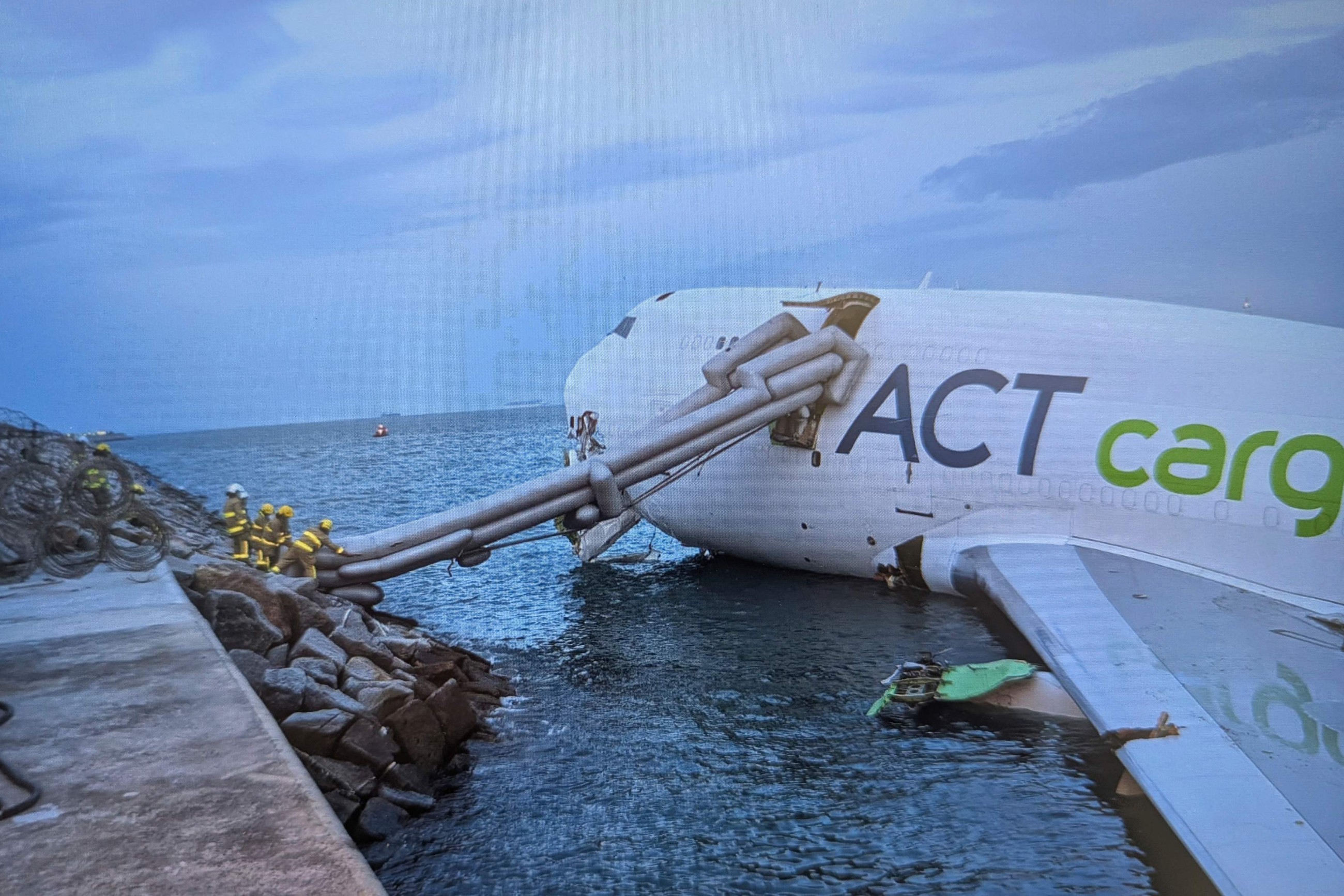 Two airport staff killed after cargo plane slides off runway in Hong Kong