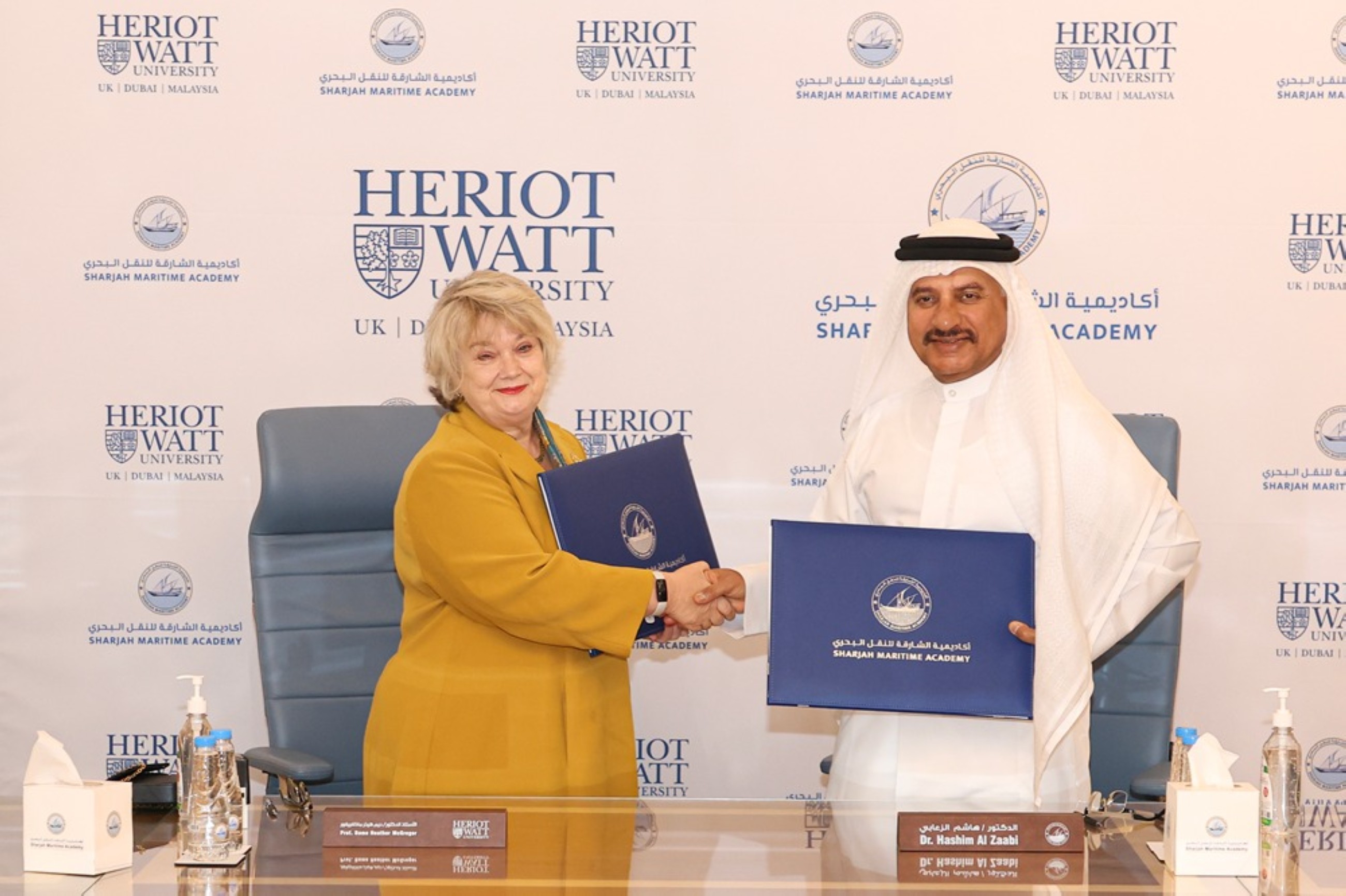 Professor Dame Heather McGregor and Dr. Hashim Al Zaabi exchange the MoU to advance Academic Cooperation and Research Excellence.