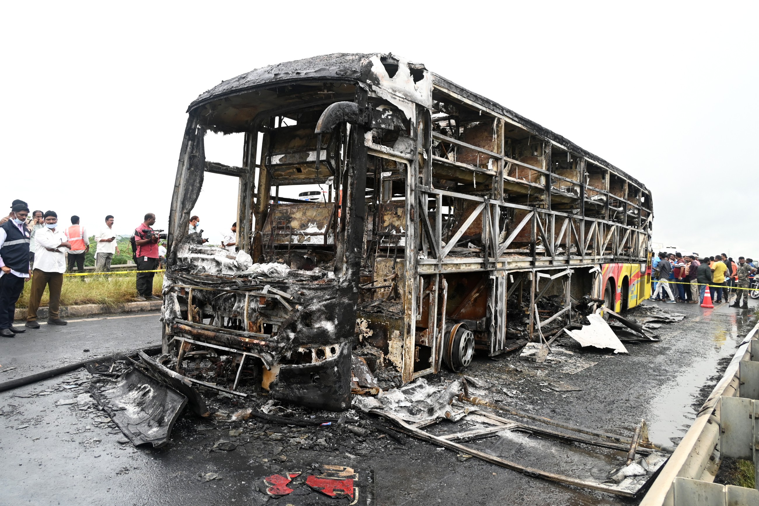 The charred remains of a passenger bus lie on a highway in Chinnatekuru village, Andhra Pradesh state, India, on Friday. AP
