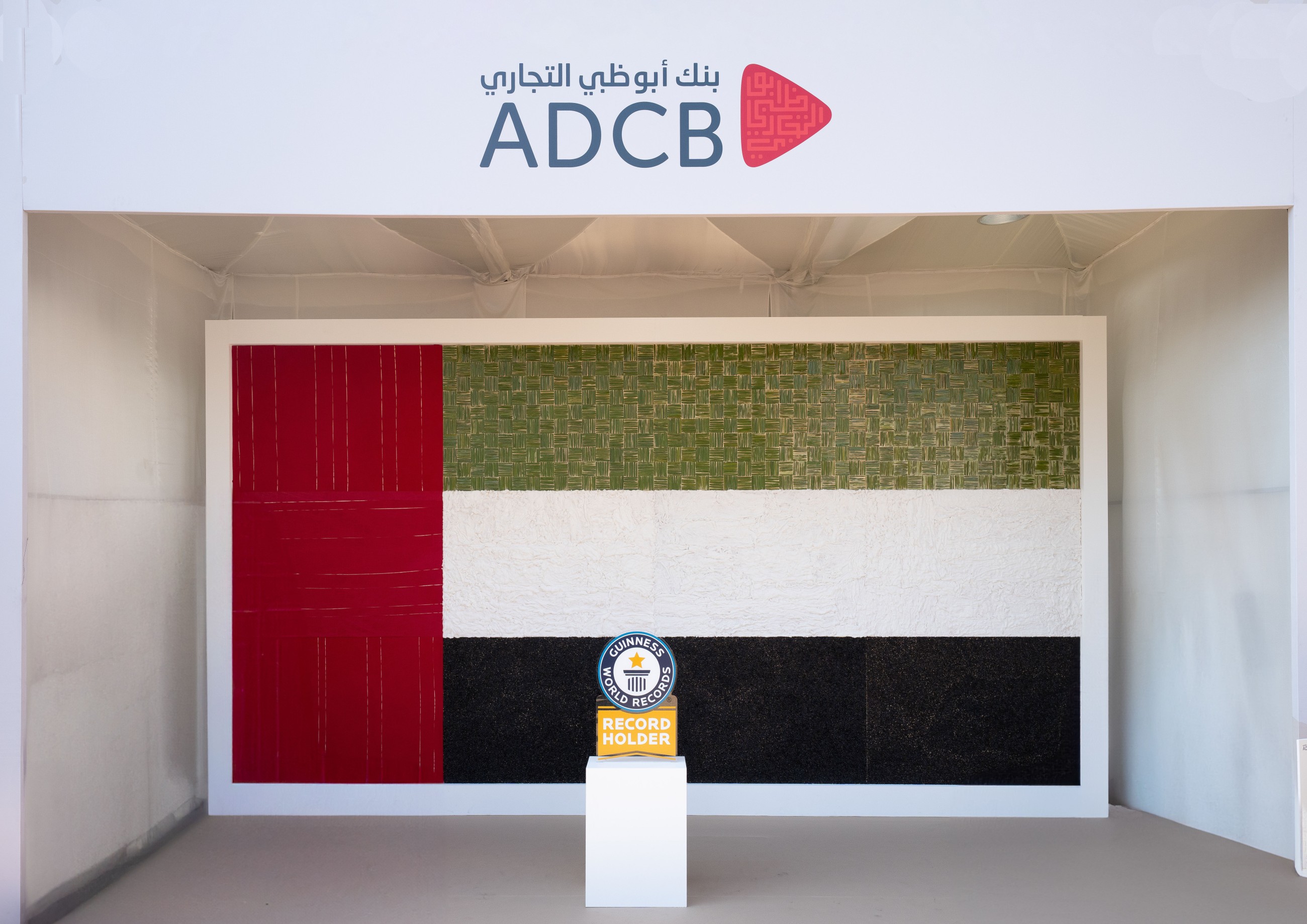 ADCB sets Guinness World Records with largest biodegradable UAE flag