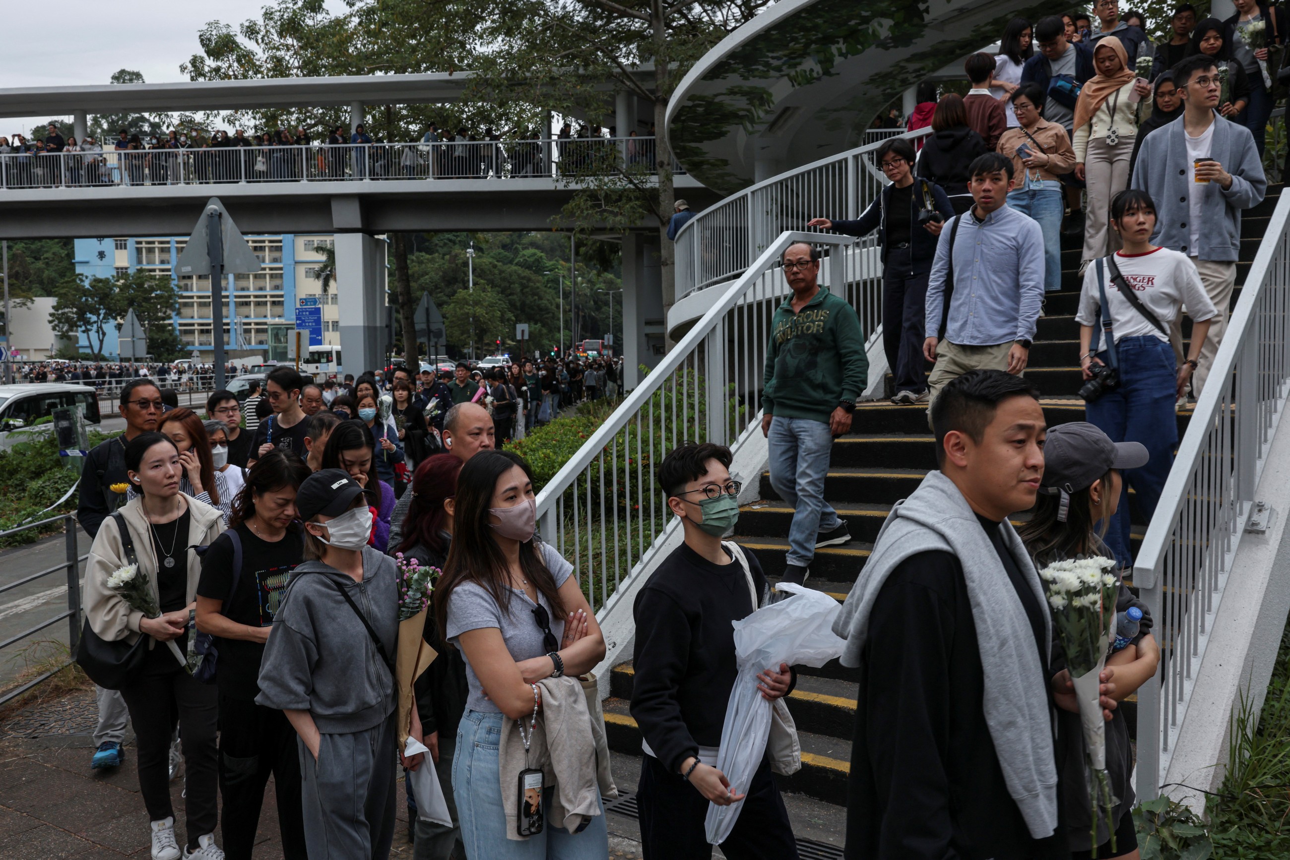 Mourners flock to site of deadly Hong Kong blaze as Beijing warns against protests
