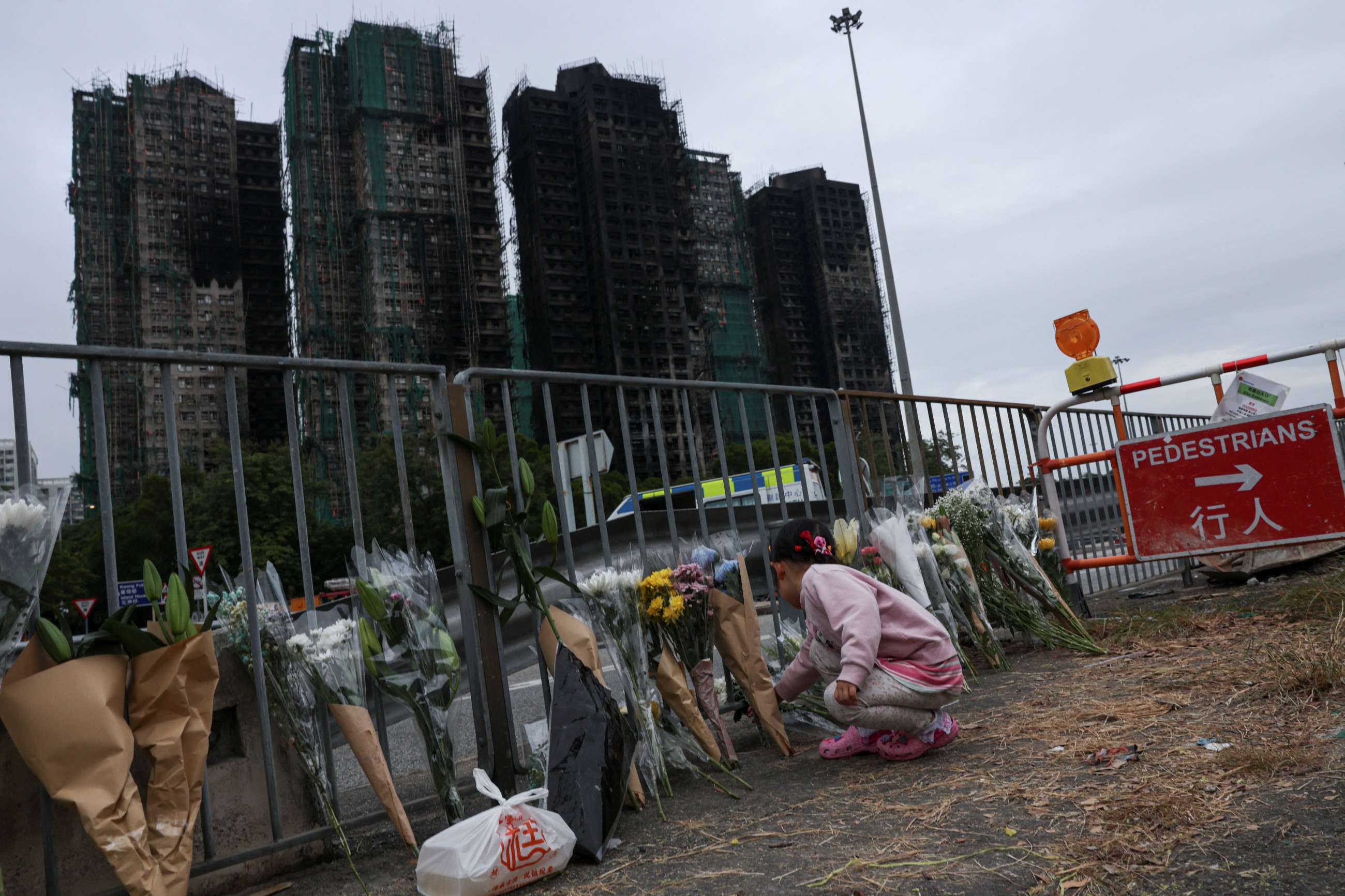 Mourners flock to site of deadly Hong Kong blaze as Beijing warns against protests