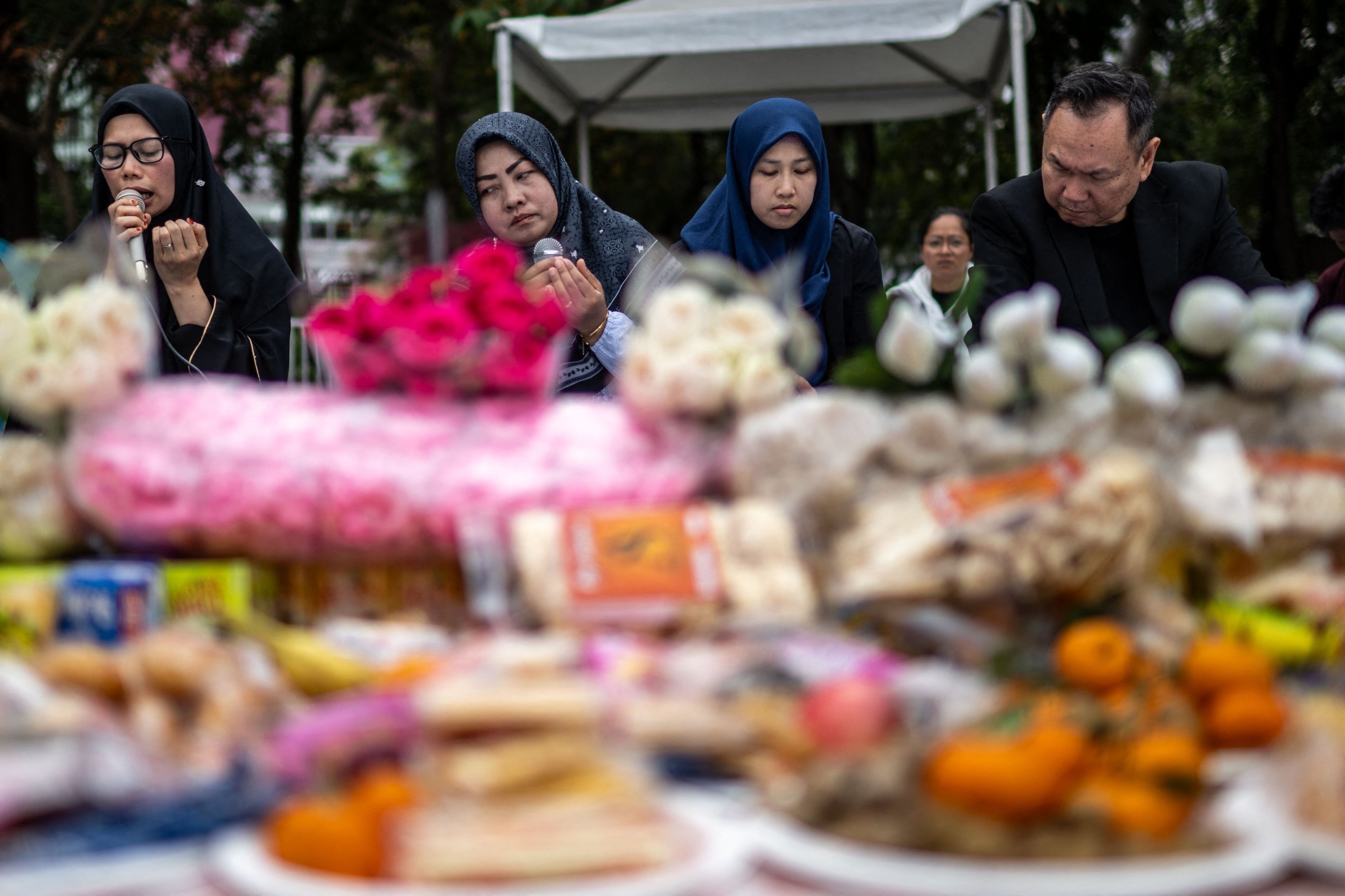 Mourners flock to site of deadly Hong Kong blaze as Beijing warns against protests