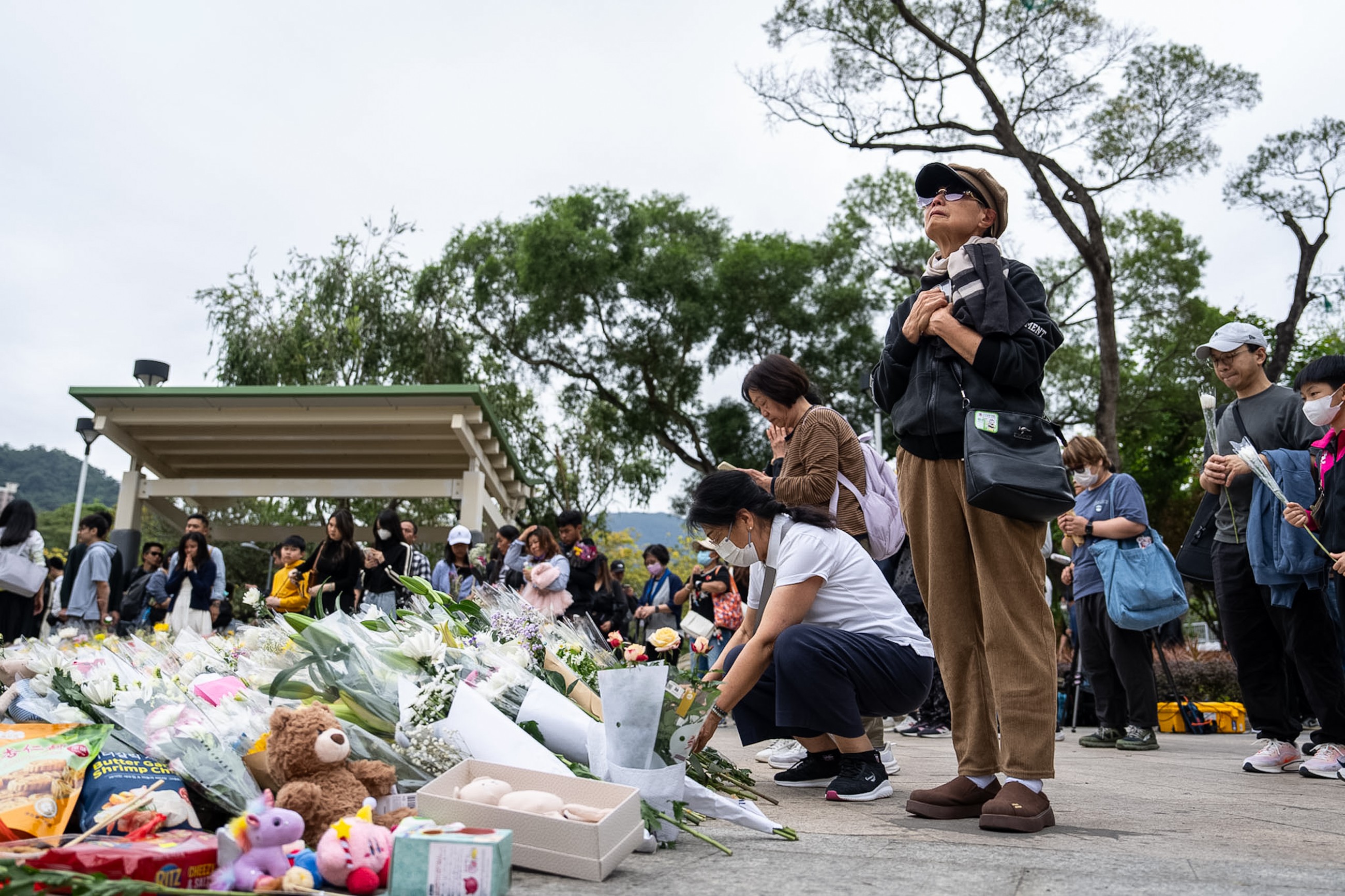 Mourners flock to site of deadly Hong Kong blaze as Beijing warns against protests