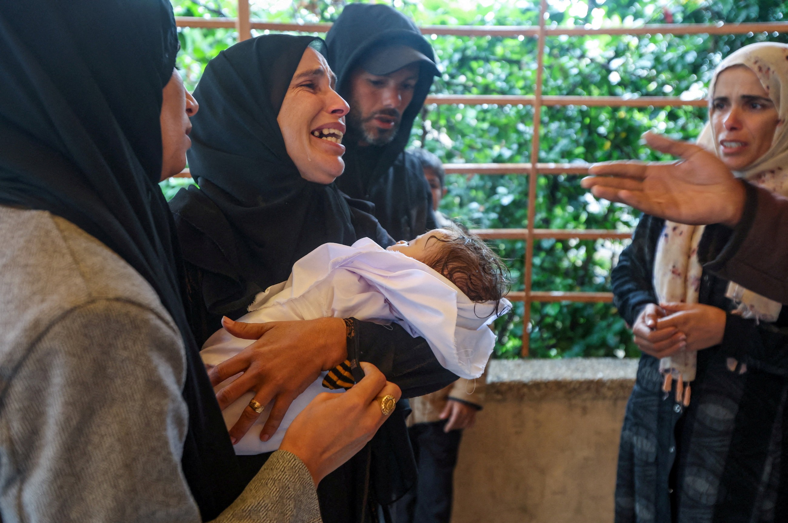 Rain has flooded Gaza tents and a baby died of exposure, say medics
