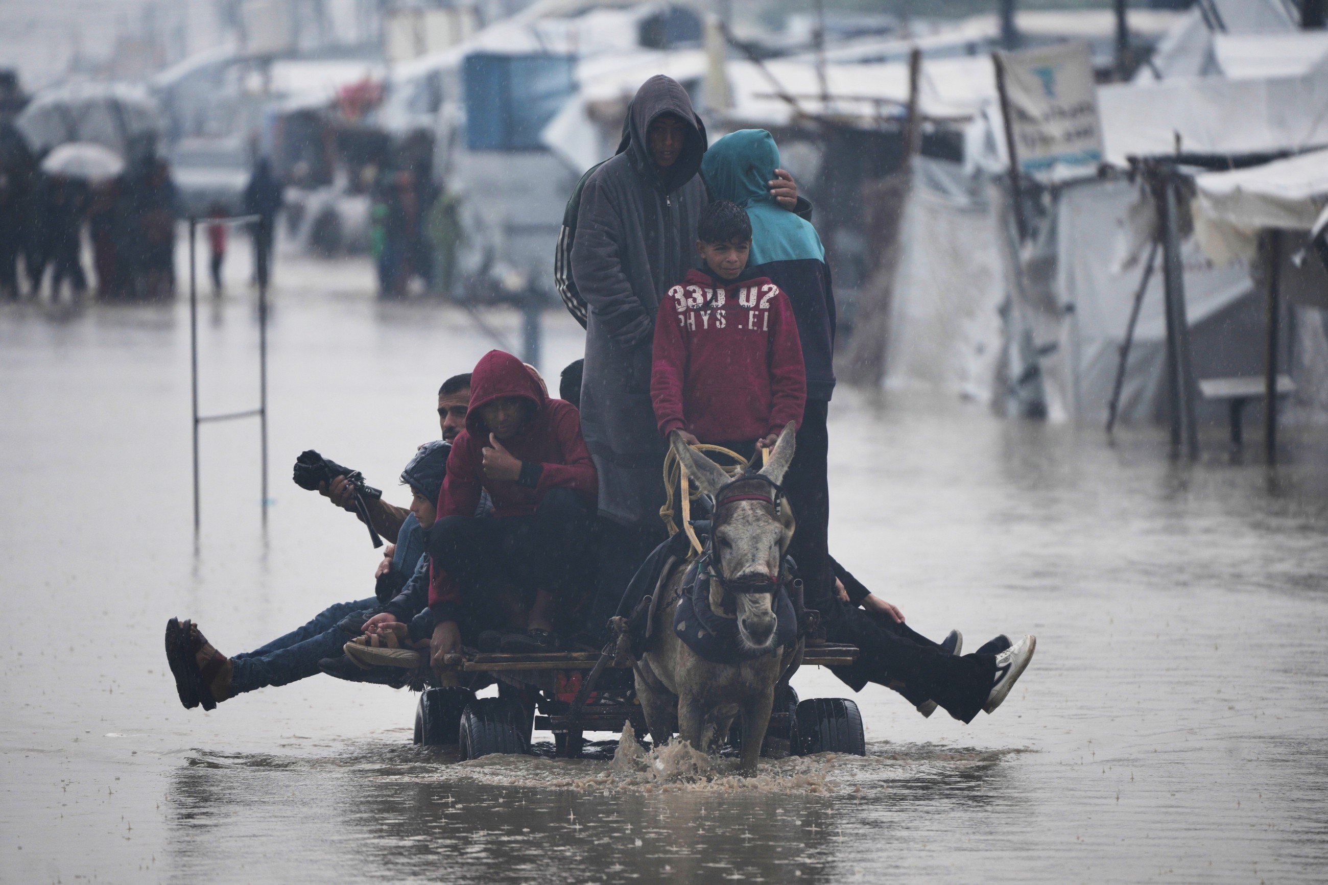 Rain has flooded Gaza tents and a baby died of exposure, say medics