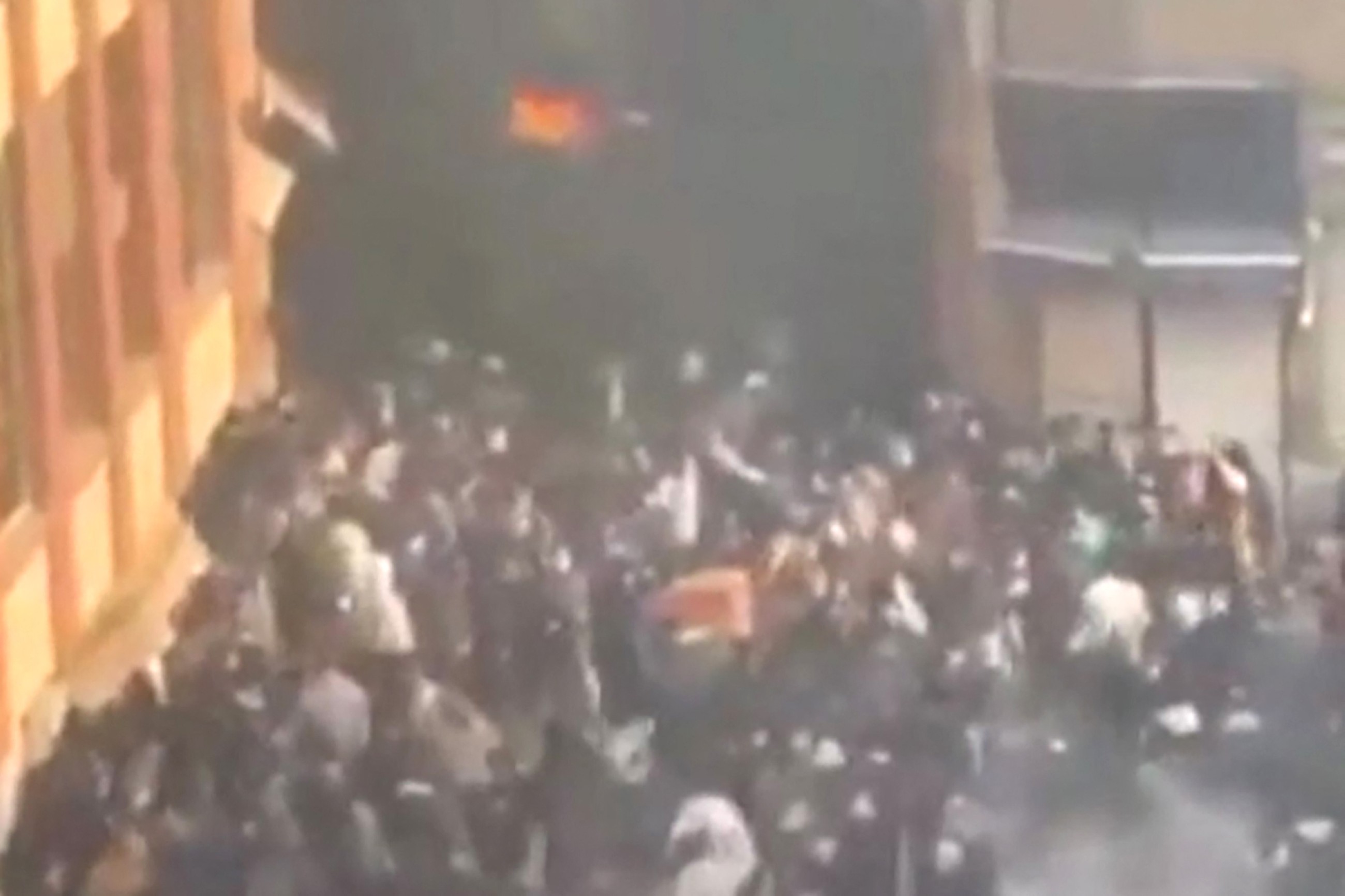 Security forces clash with protesters in Iran's main market as toll rises to 36