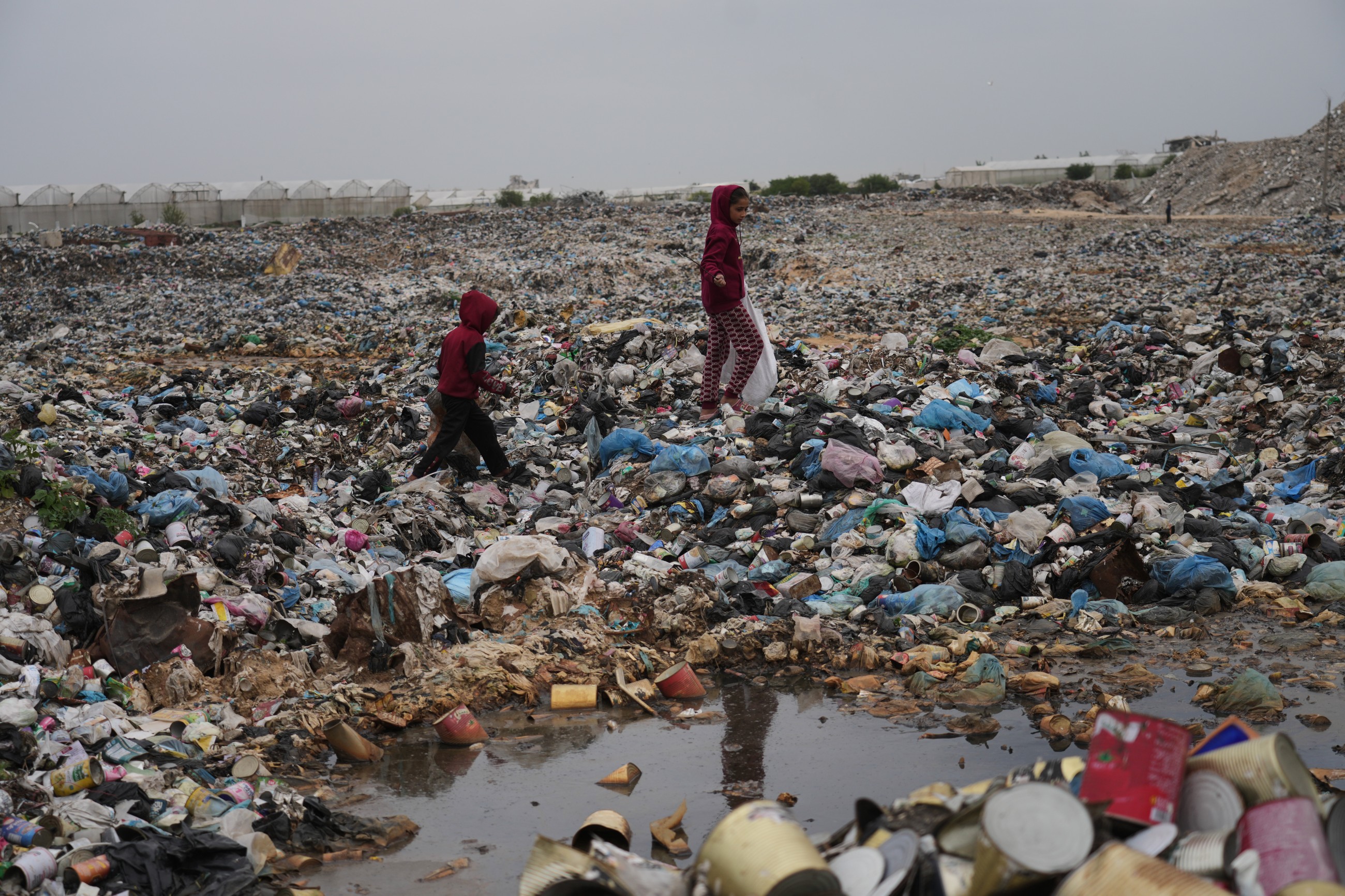 Desperate Gazans dig through garbage for heat to stay warm