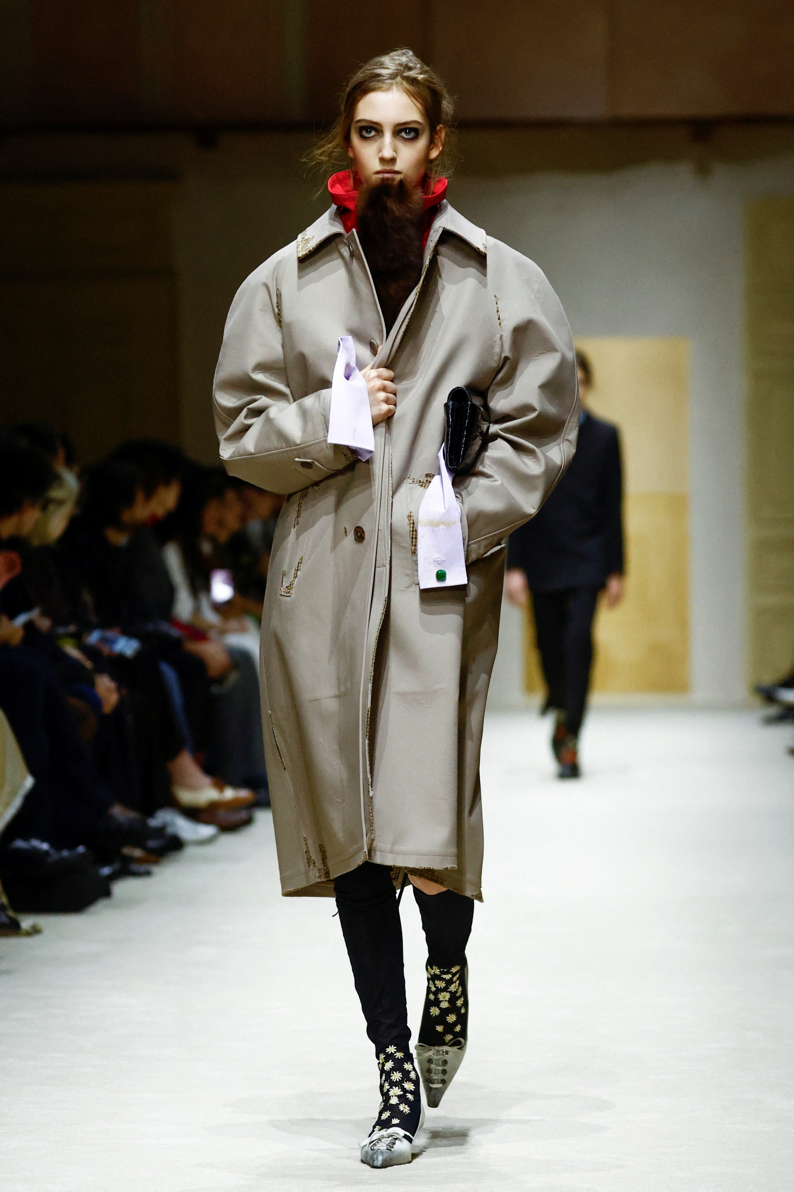 Prada layers winter jackets over light dresses at Milan Fashion Week