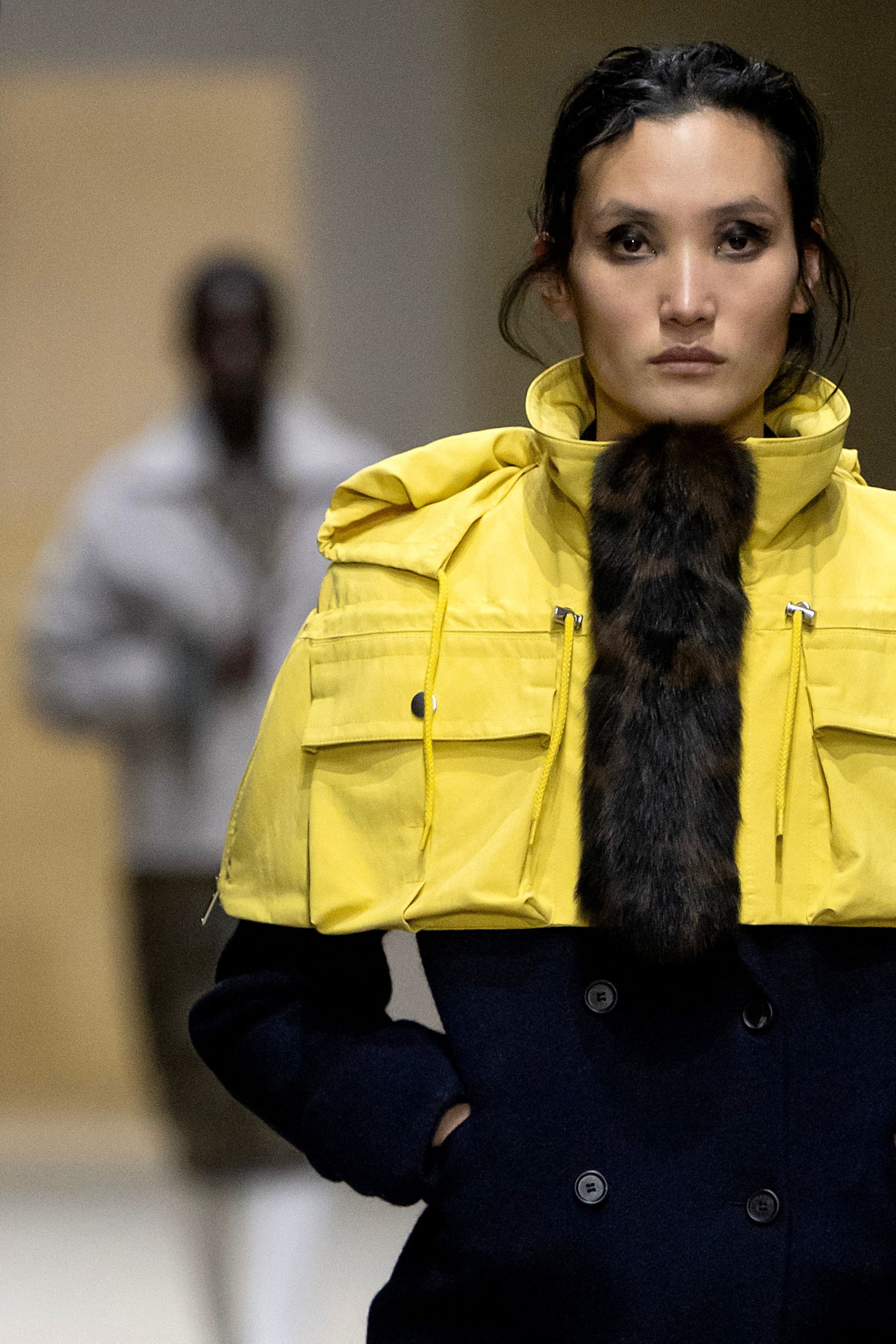 Prada layers winter jackets over light dresses at Milan Fashion Week