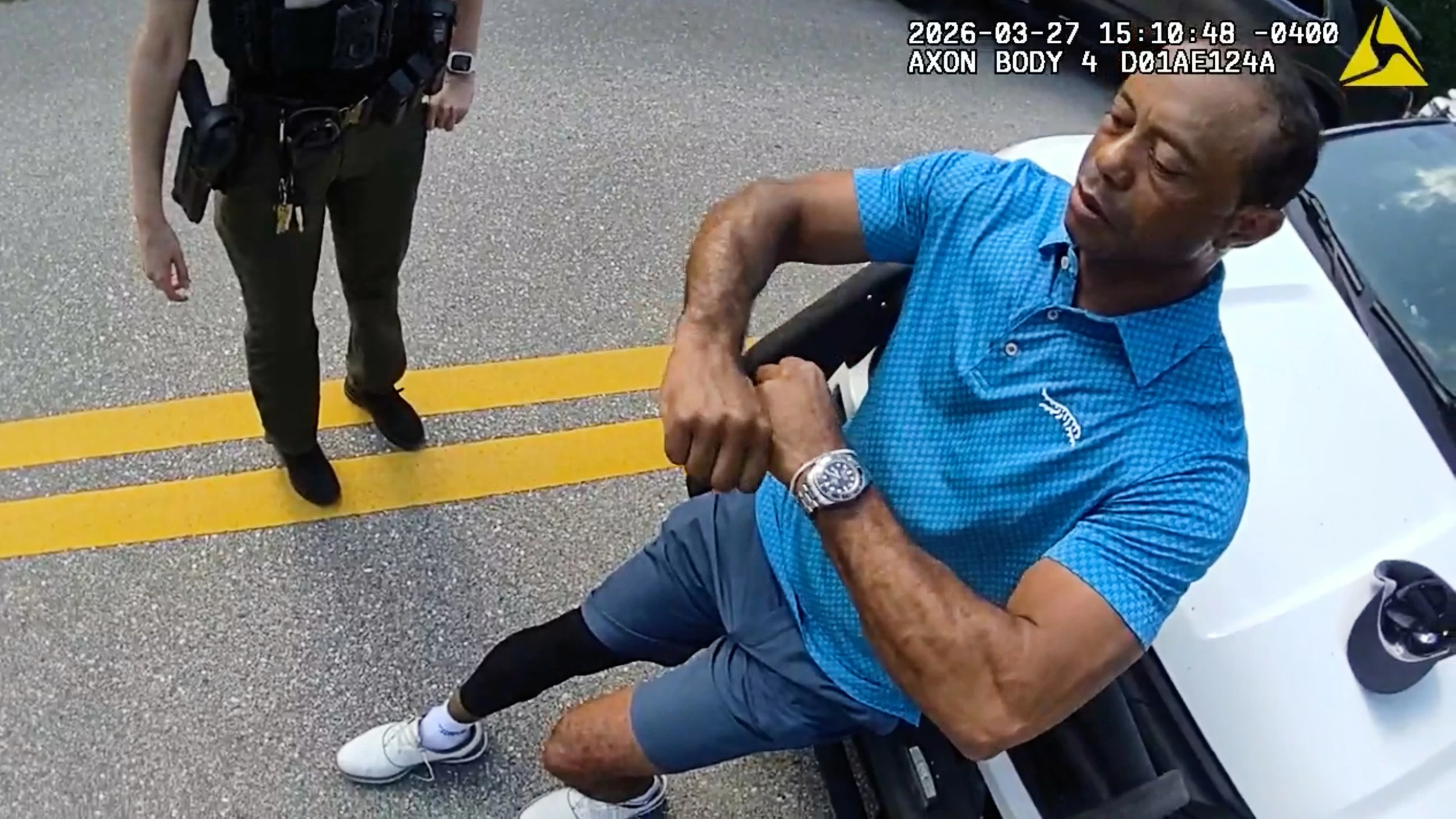 Stunned Tiger Woods handcuffed after Florida rollover crash, bodycam shows