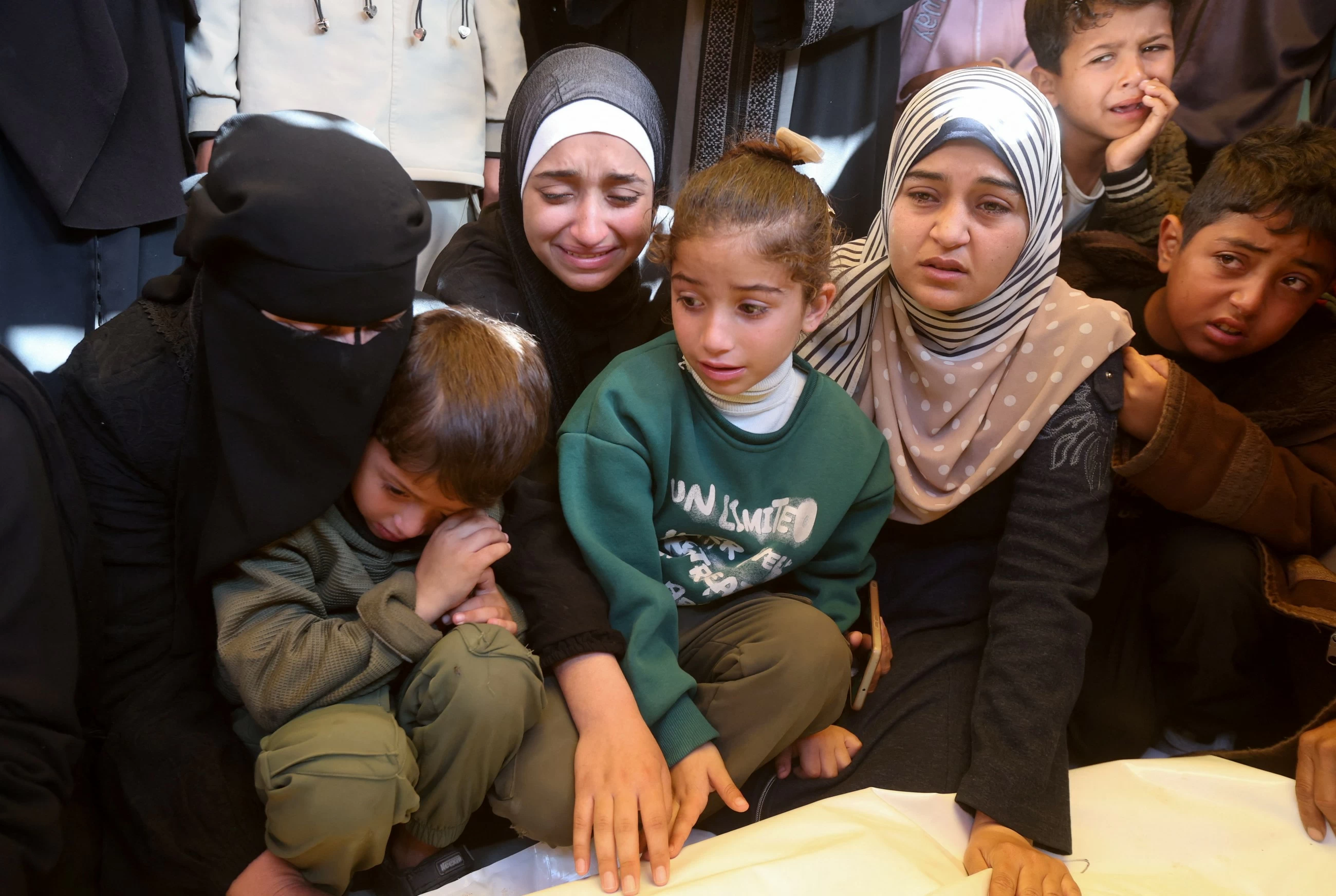 Palestinians hold funerals for pregnant woman and her children killed in Israeli strikes