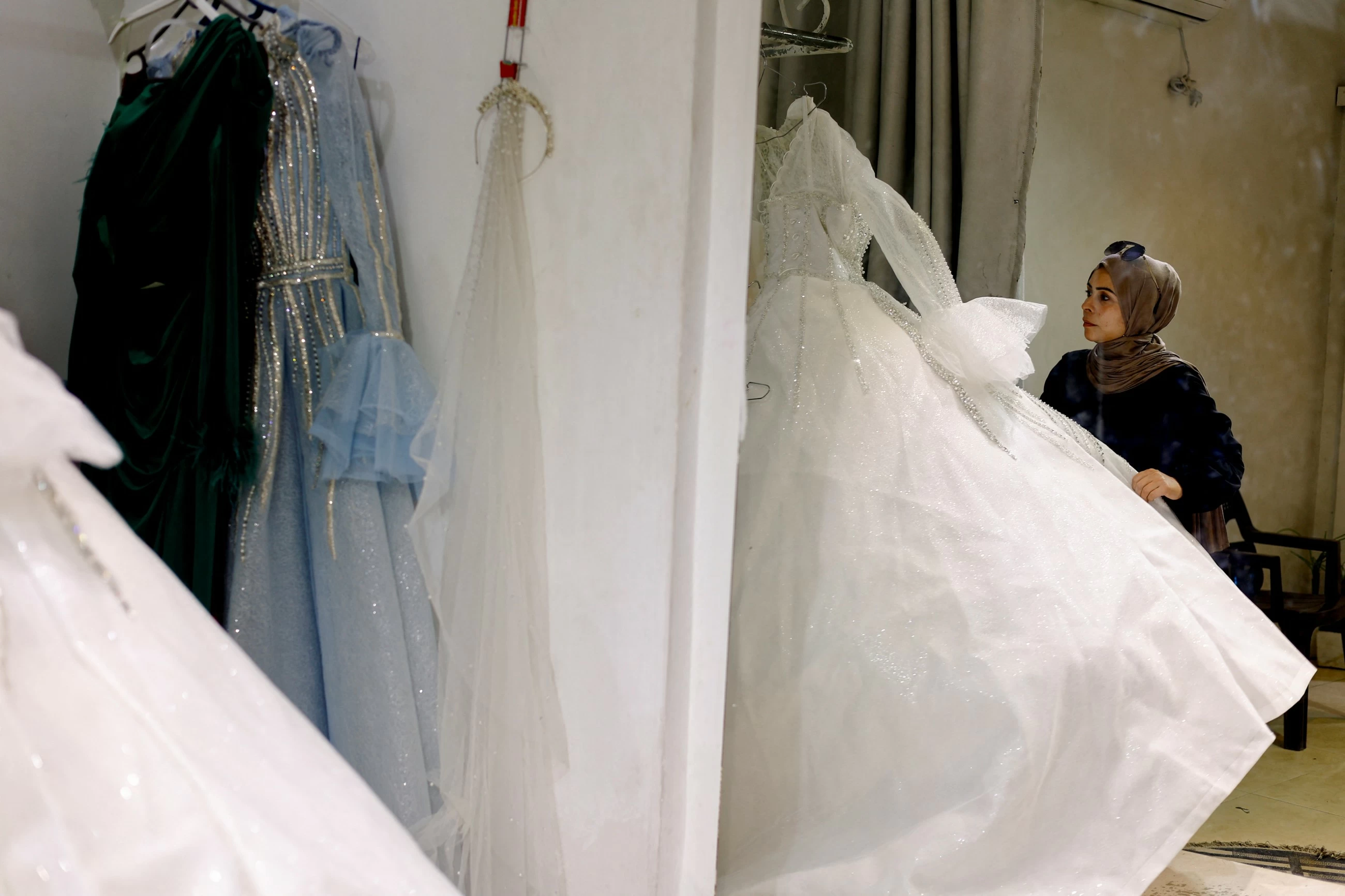 In war‑scarred Gaza, brides turn to refurbished wedding dresses