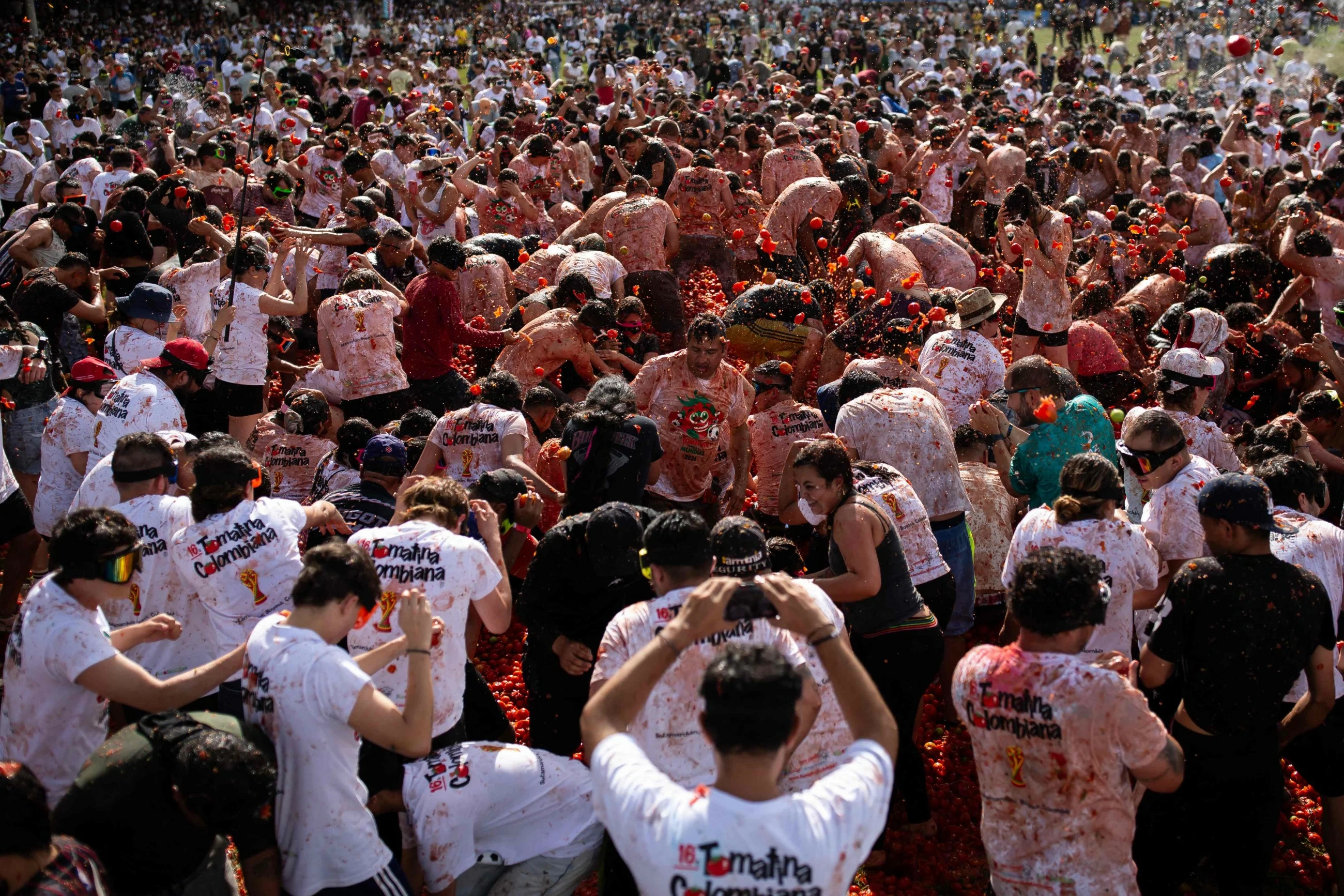 Thousands of revellers pelt each other with tomatoes at annual Tomatina festival in Colombia