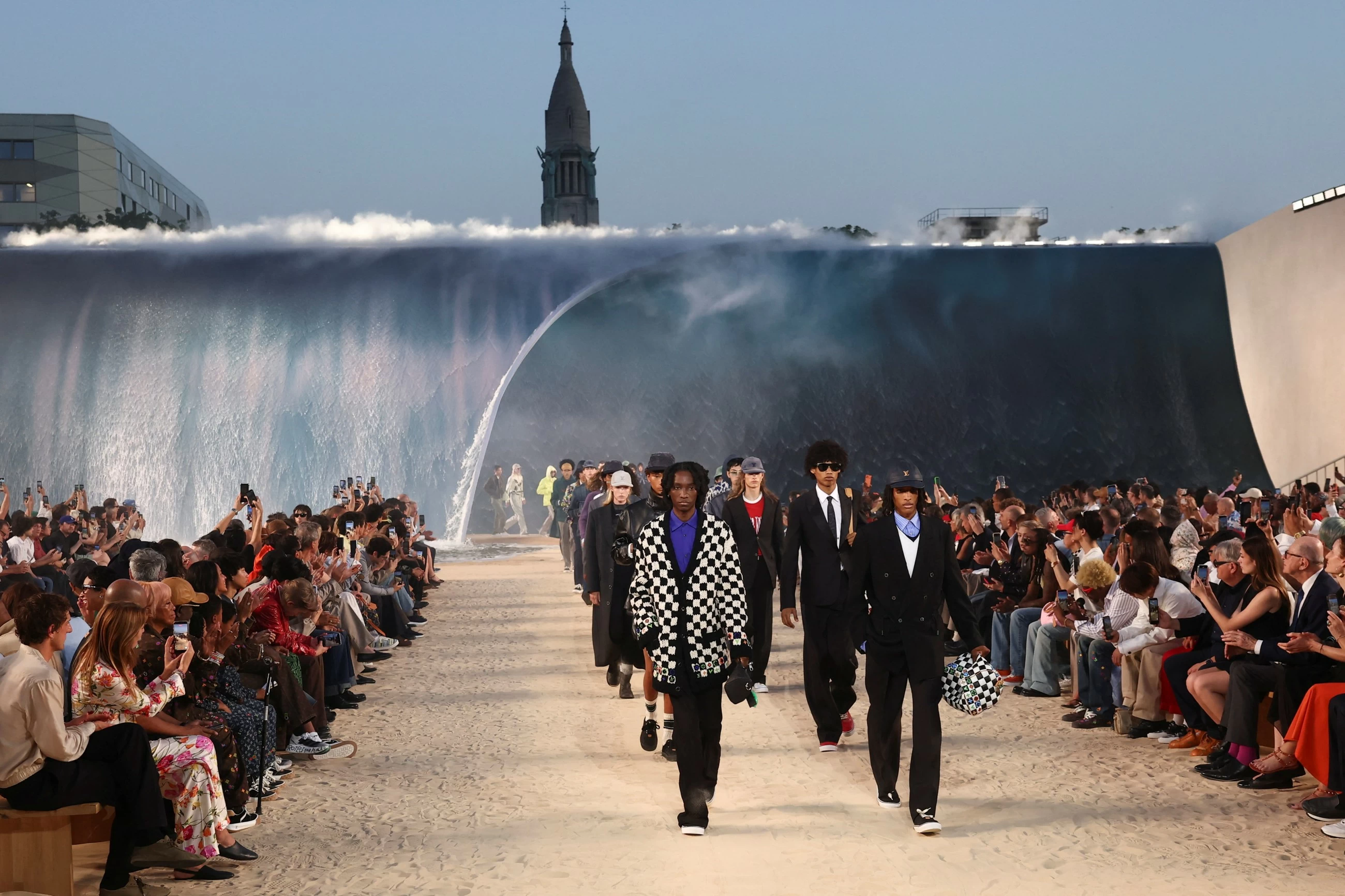 Louis Vuitton designer Pharrell Williams uses giant tidal wave set as backdrop for Paris fashion show