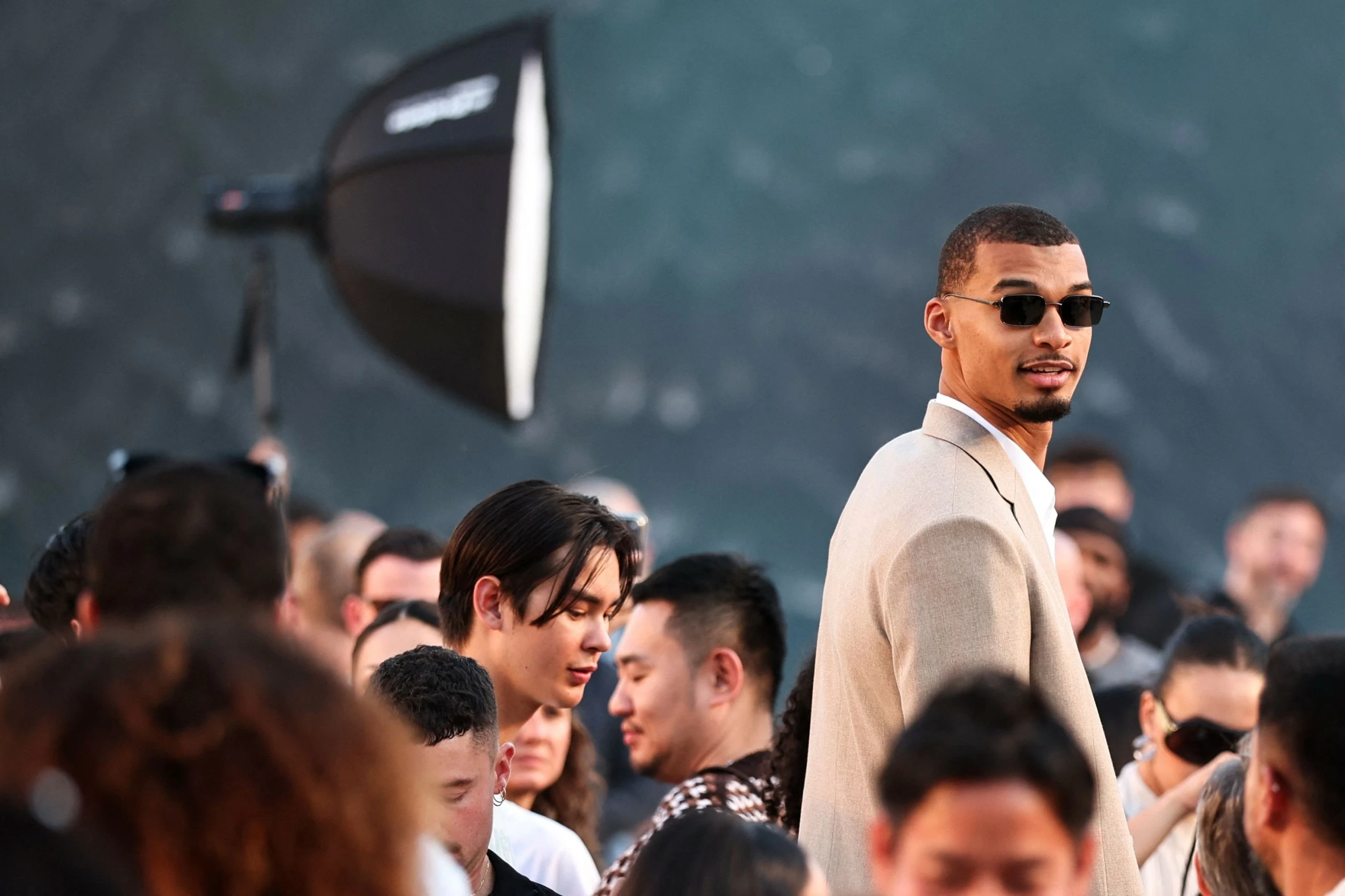 Louis Vuitton designer Pharrell Williams uses giant tidal wave set as backdrop for Paris fashion show