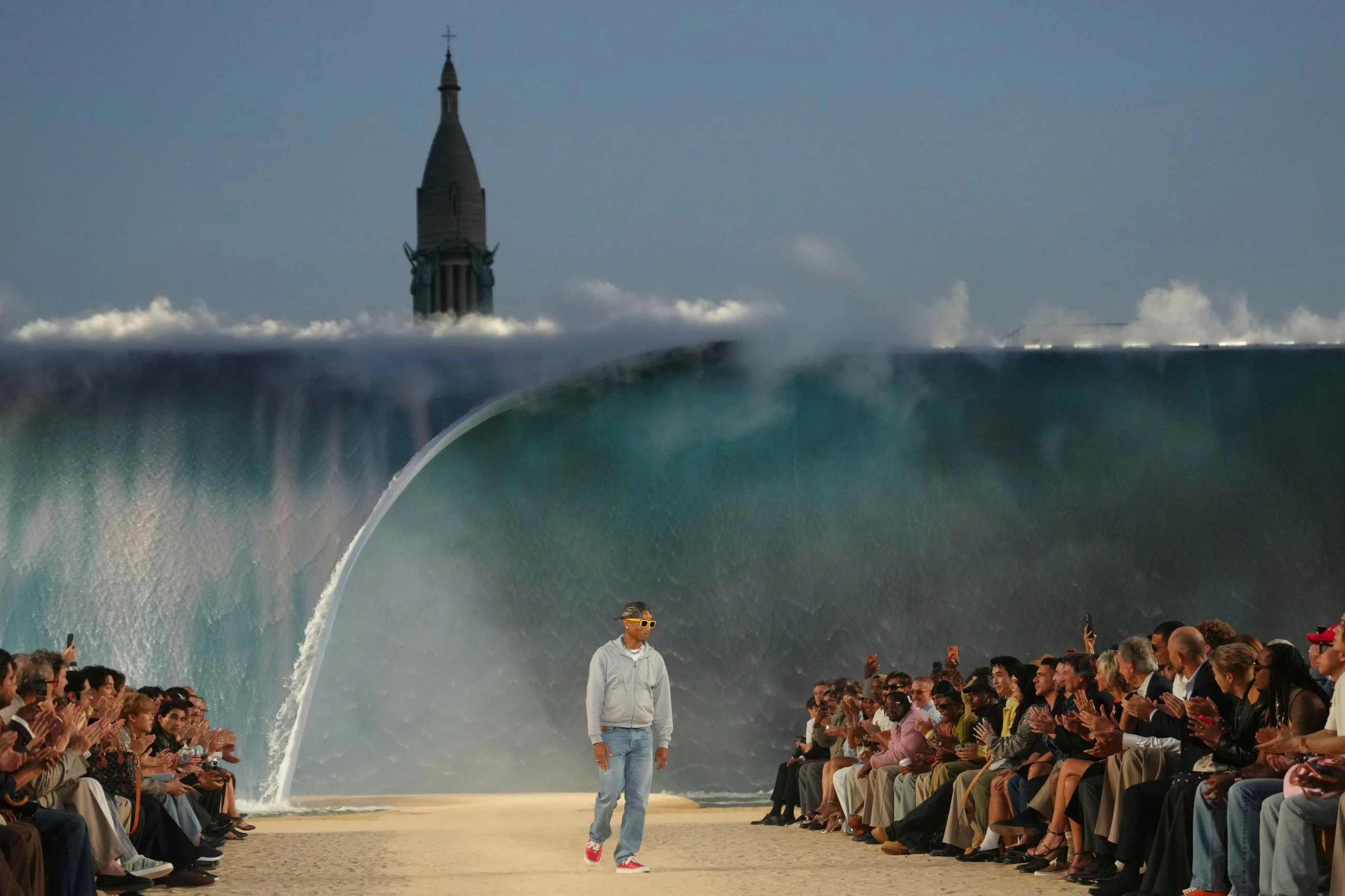 Louis Vuitton designer Pharrell Williams uses giant tidal wave set as backdrop for Paris fashion show