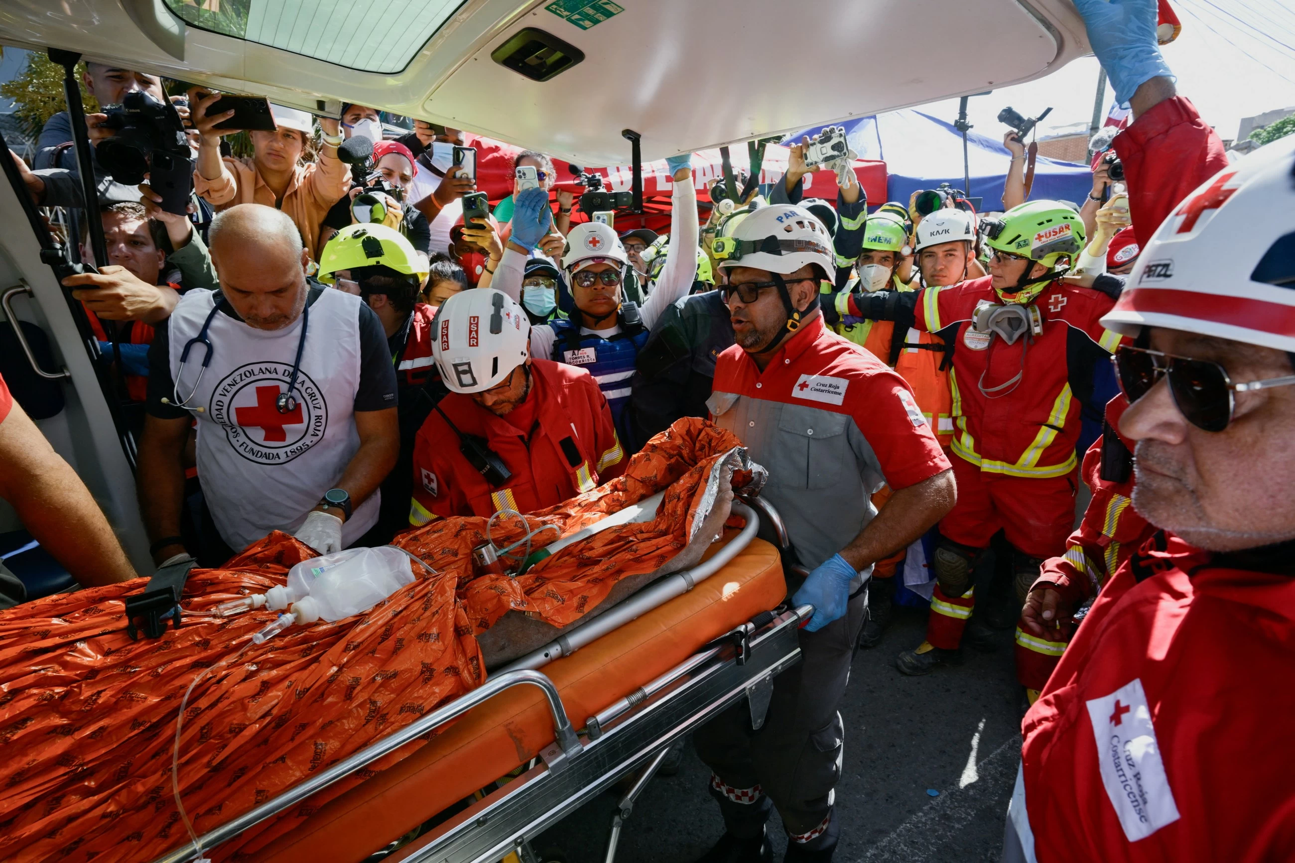 Rescuers dig out Venezuelan security guard 8 days after quakes; death toll nears 2,300