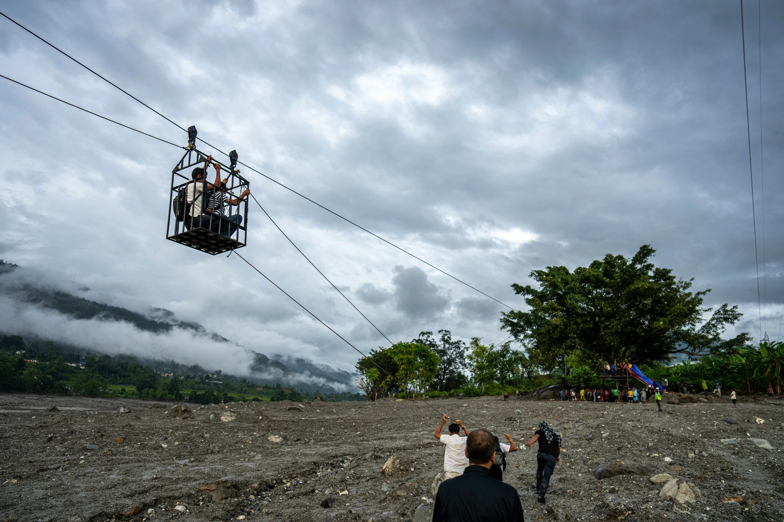 Nepal flood survivors cling to zipline to cross treacherous river